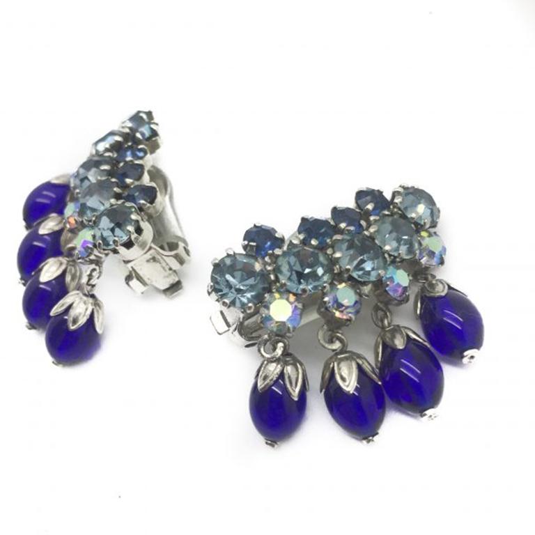 Fabulous and Fun! 1950s Vintage Earclimber Earrings. Wonderful detail and workmanship and a pure en trend style to boot. Featuring individually hand set crystals and flower capped blue glass dangles all set in a silver-tone metal. In very good