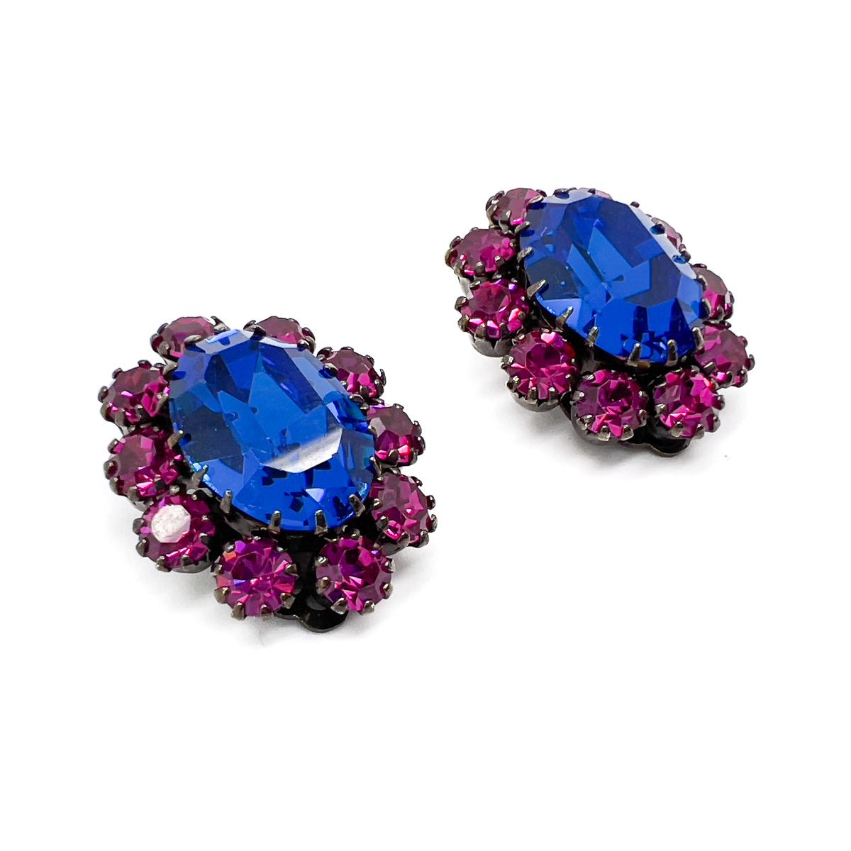 A stunning pair of mid-century Vintage Electric Blue Earrings. The large electric blue crystal sitting within a wonderfully contrasting gallery of hot pink crystals. Each stone claw set to perfection in this timeless cluster style. An adorable