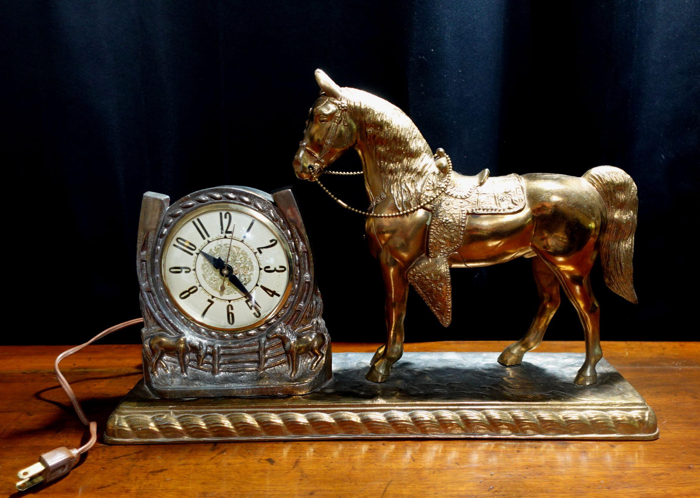 A beautiful Horse Mental Clock. It's electrical and runs very accurately. It depicts a large standing golden horse right next to the clock and becomes a charming decorative object with the time displaying function.