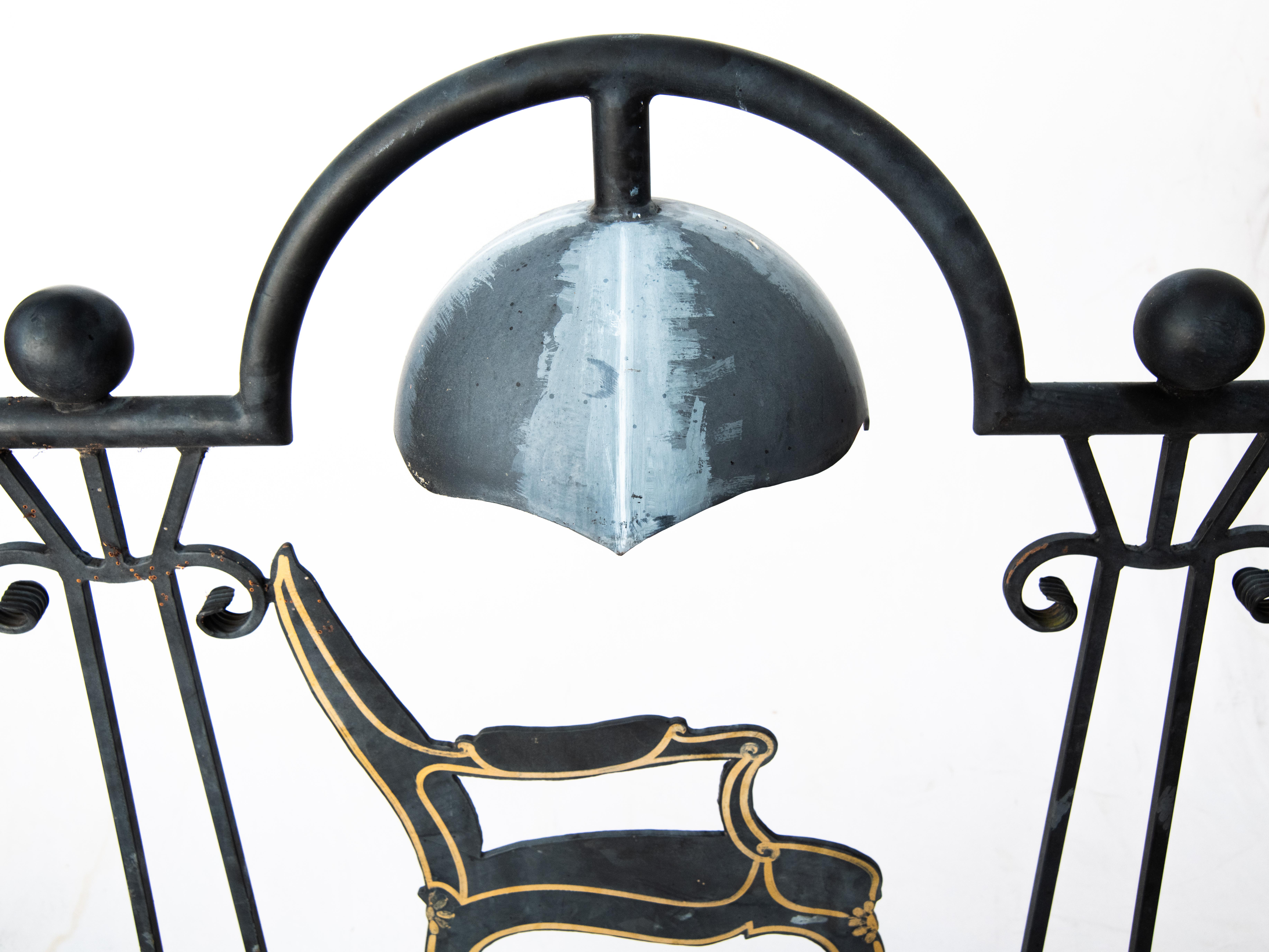 Vintage wrought iron exterior shop sign for antique/furniture/interior design business. Painted black with gold accents. Wired with a light bulb socket concealed in the 