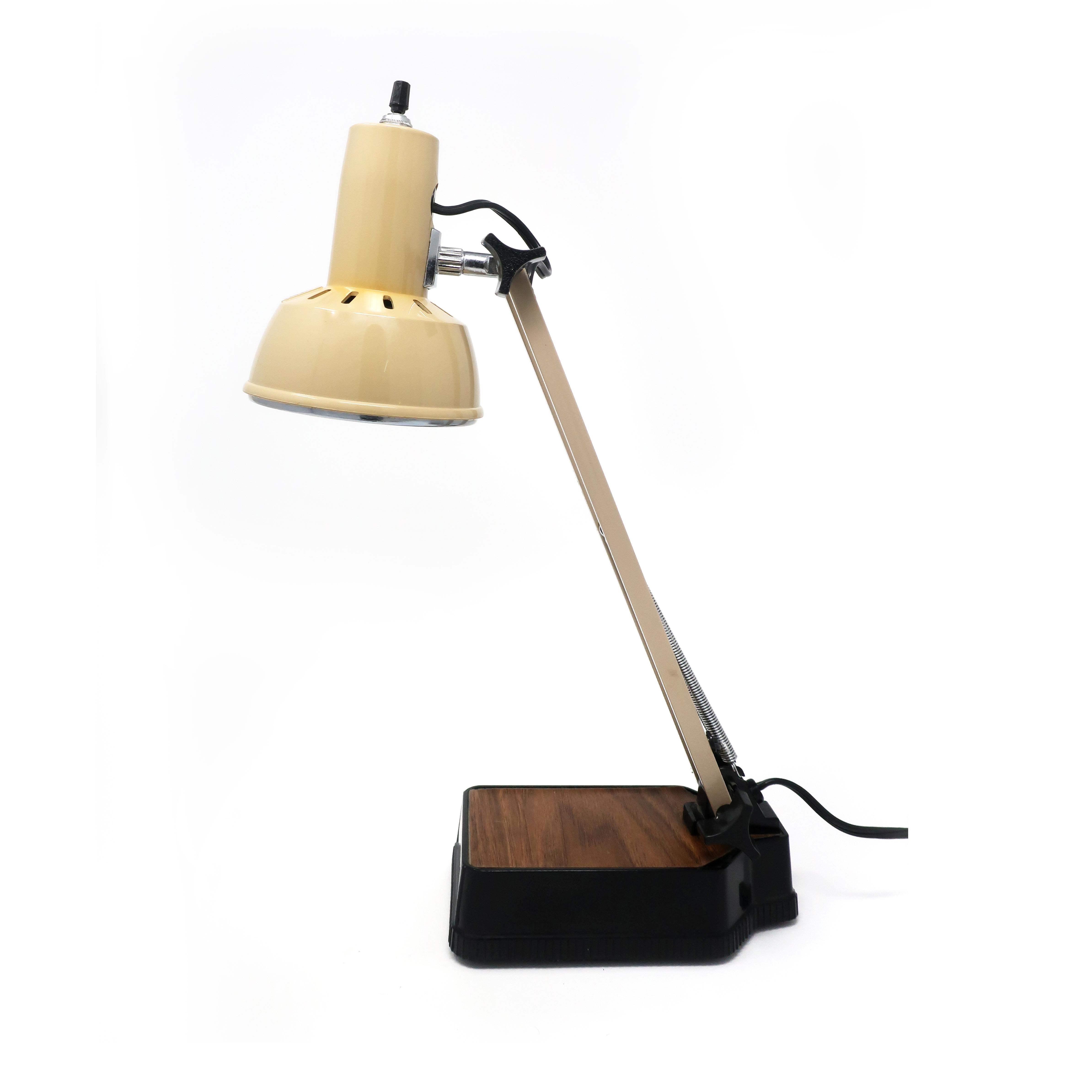 A Mid-Century Modern adjustable desk lamp with black and wood grain base, tan metal stem, and tap plastic shade. Marked “Electric” on shade and on bottom 