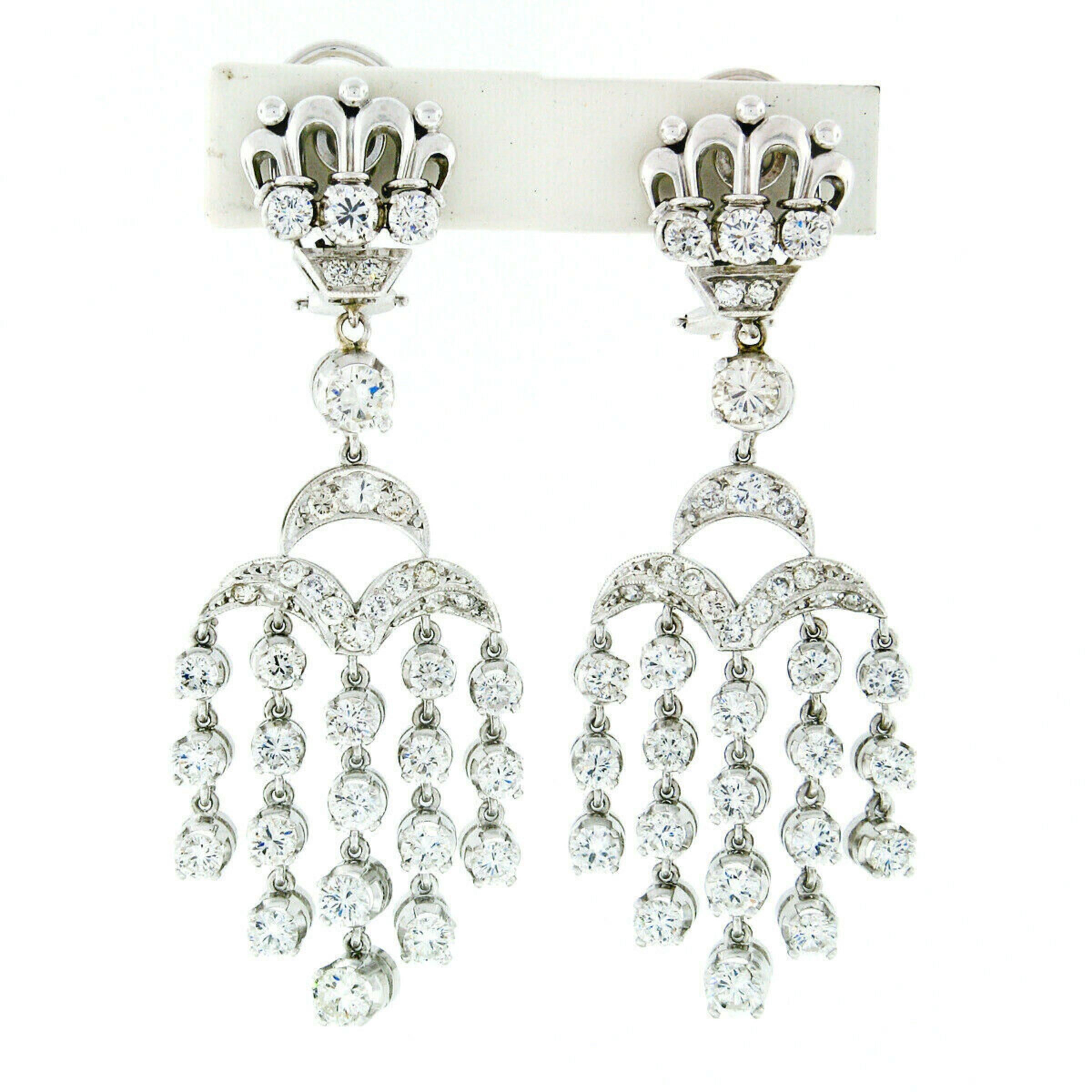 You are looking at a breathtaking pair of chandelier dangle earrings that were crafted from solid 18k white gold and set with approximately 5.38 carats of very fine quality diamonds. The dangling strands of diamonds are very flexible and flow