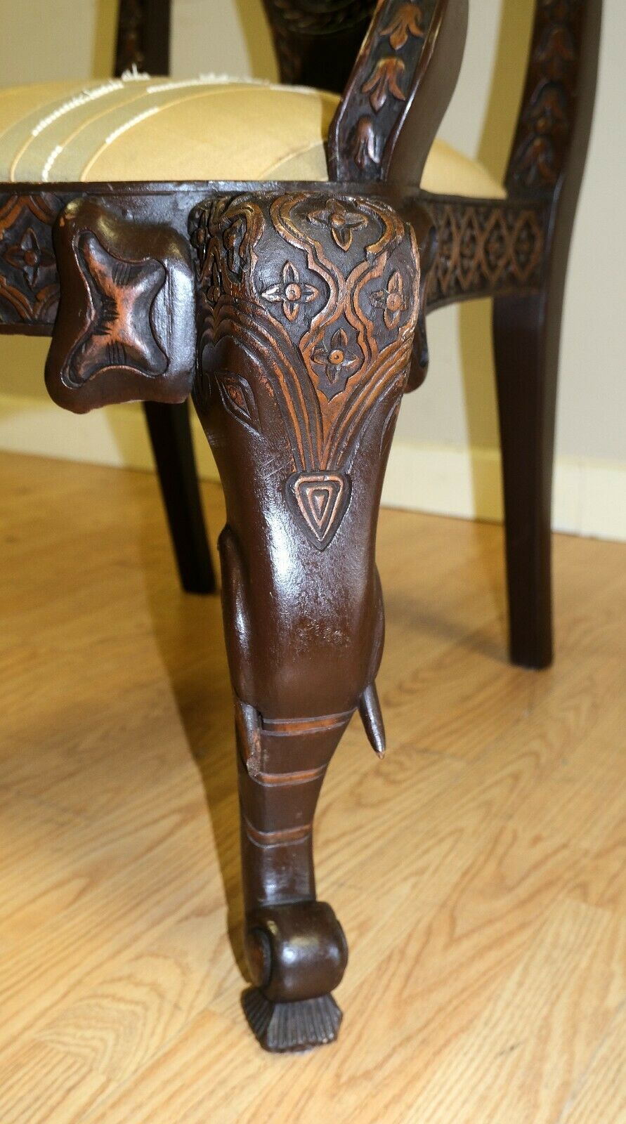 We are delighted to offer for sale this lovely hand carved with Elephant legs armchair with fabric seat.

The armchair is beautifully presented with elephant carved front legs, along with lovely carved padded armrests. The back splat support shows