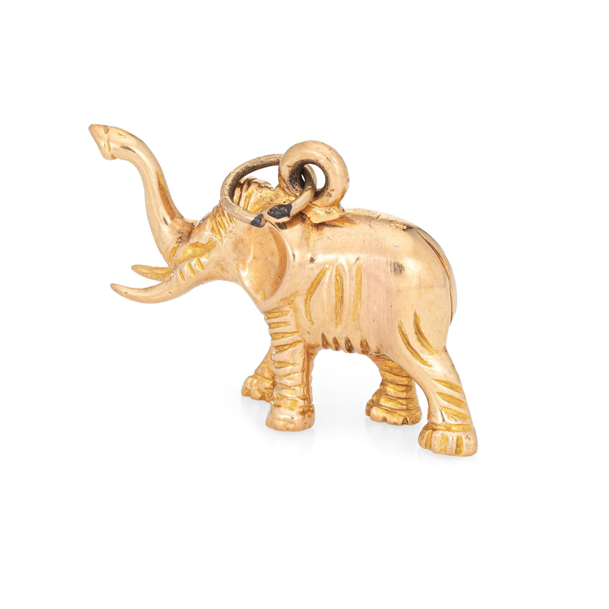 Finely detailed vintage Elephant charm crafted in 18k yellow gold.  

The elephant is in standing pose with it's trunk raised. The charm is solid with a heavier weight feel to the touch (10.3 grams). The piece can be worn as charm on a bracelet or