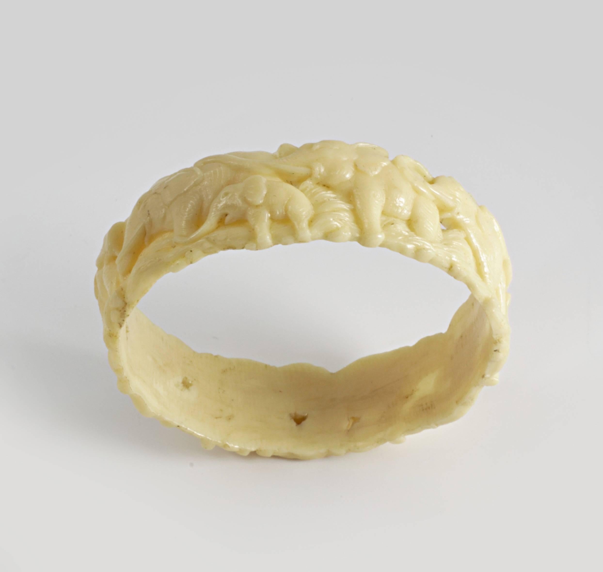Beautiful highly moulded Ivory coloured Celluloid bangle, made in Japan in the 1930′s, complete with vertical join.

The bangle depicts a herd or parade of Elephant and baby elephants, all with their trunks facing upwards representing good luck.

A