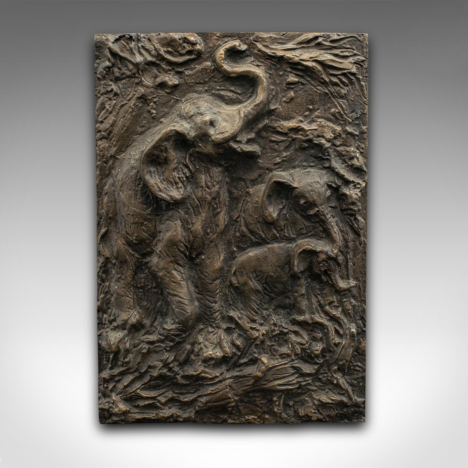 This is a vintage elephant relief plaque. An English, bronze outdoor plate, dating to the mid 20th century, circa 1960.

Appealing relief with charming elephant decor
Displays a desirable aged patina and in good original order
Bronze presents