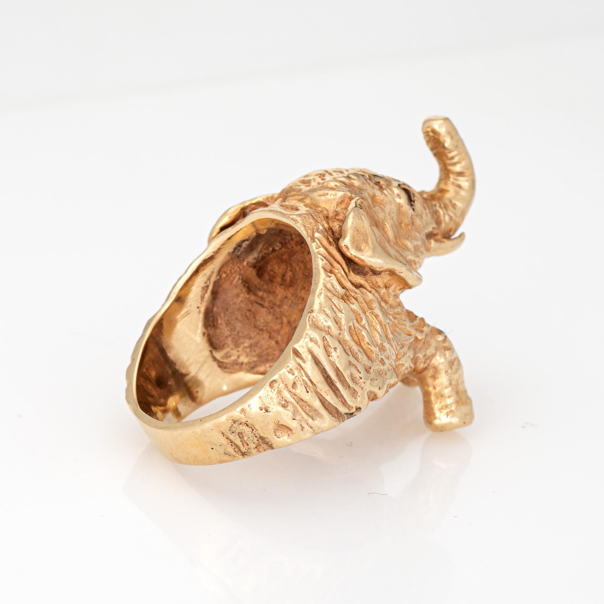 Distinct & stylish vintage elephant ring (circa 1960s to 1970s) crafted in 14 karat yellow gold. 

Two small diamonds are set into the eyes and total an estimated 0.02 carats (estimated at H-I color and SI1-2 clarity). 

The sweet ring highlights a