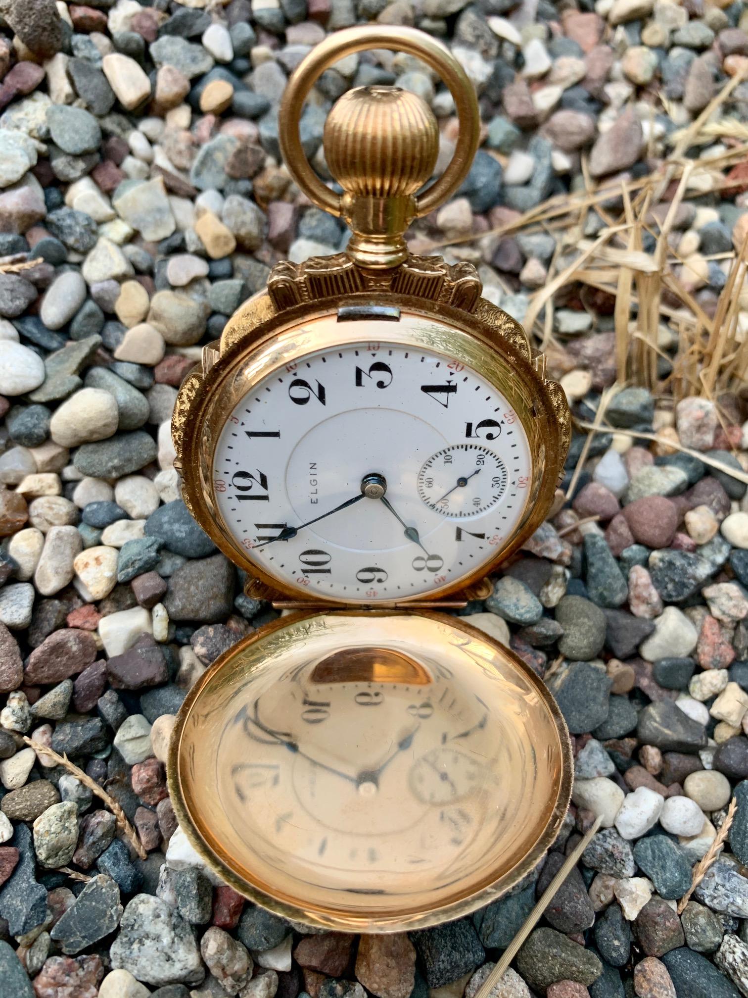 this pocket watch is absolutely amazing!!!  This piece is from the owner's personal collection and is certainly one of our shop's favorites.

This piece is made by Elgin. It is a 21 jewel piece; movement no. 1 #348.    It is adorned with a diamond