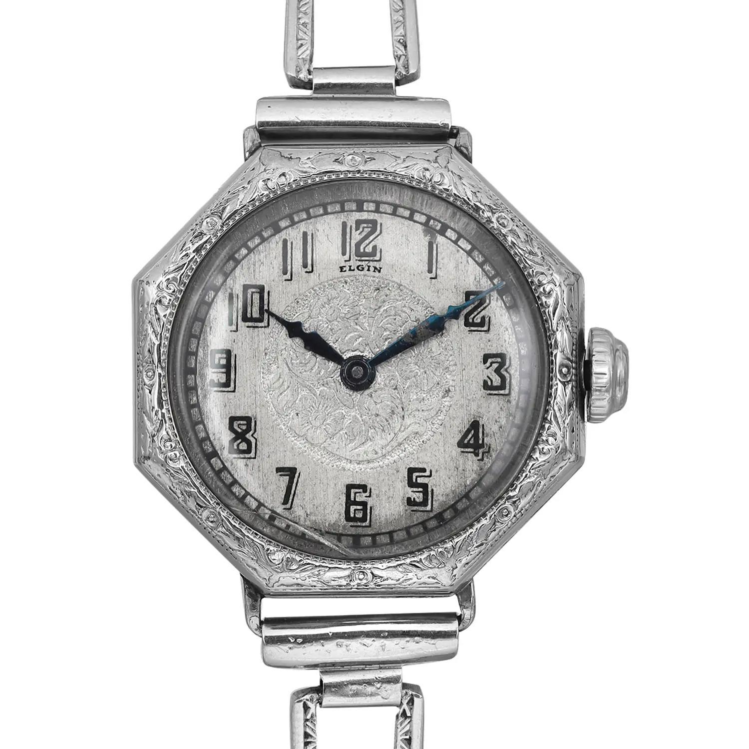 Pre-owned Elgin Vintage Octagonal Shaped 14k White Gold Filled Silver Floral Dial Wristwatch. Patina on the Dial, Blue Hands Showing Rust. No Original Box and Papers are Included. 

Brand: Elgin  Type: Wristwatch  Department: Women  Style: Classic 