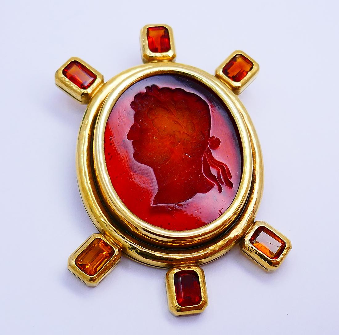         A beautiful Elizabeth Locke 18 karat gold Venetian glass brooch with citrine.
	The vintage brooch is a cameo etched in Venetian glass. To make their gorgeous intaglio pieces, Elizabeth Locke’s brand uses 17th century glass molds. Usually,