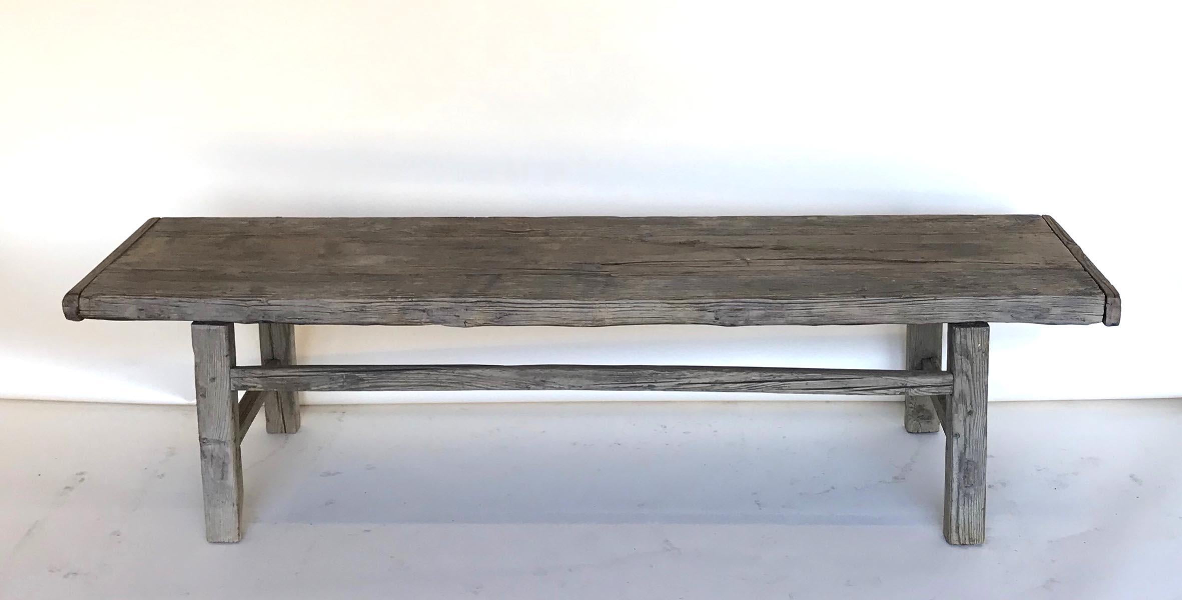 Vintage elm bench with stretchers. Mortise and Tenon construction. Lovely naturally distressed, smooth patina on wood. Can work as a bench, low console or coffee table.