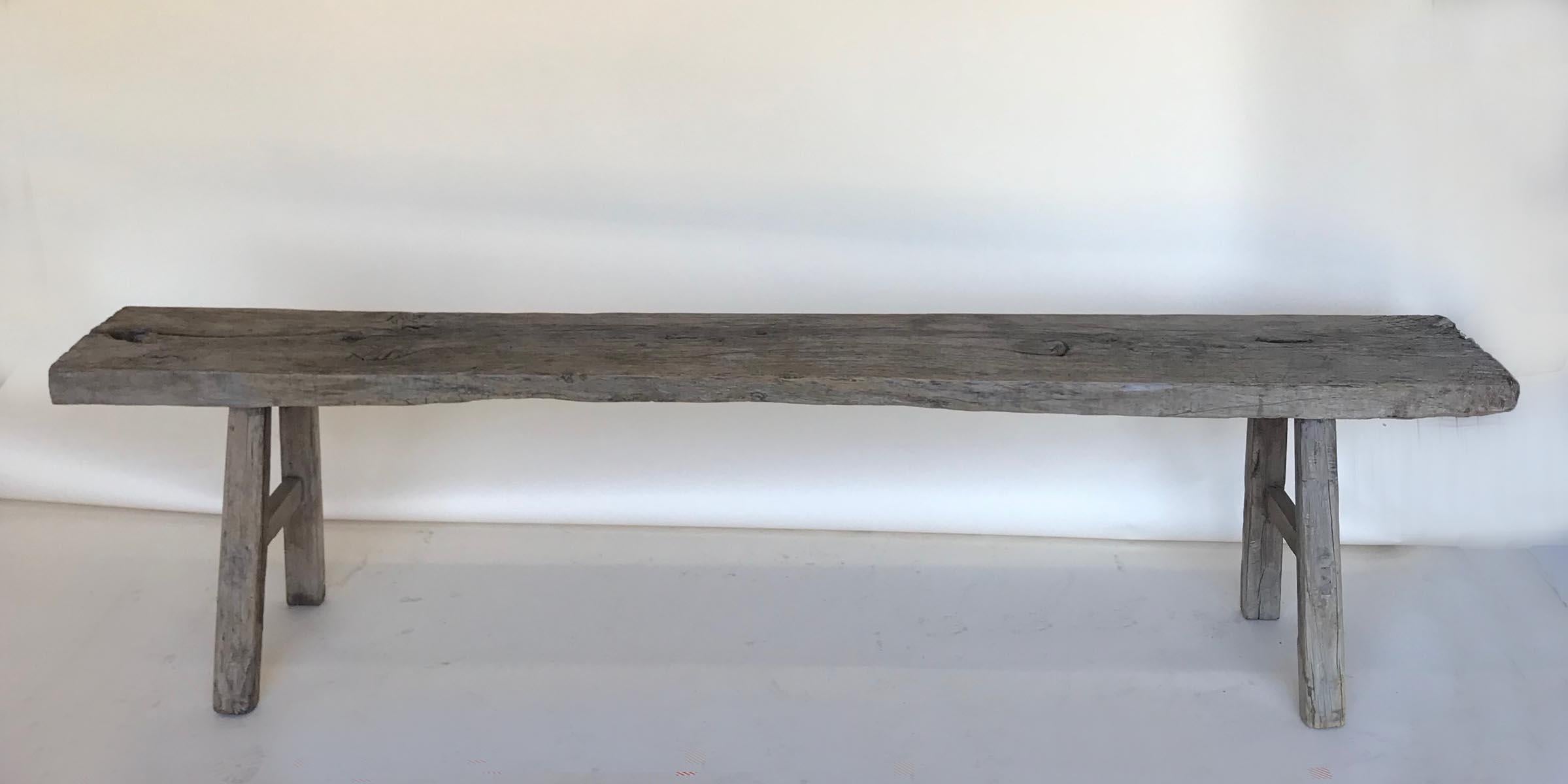 Vintage elm bench with stretchers. Mortise and tenon construction. Lovely naturally distressed, smooth patina on wood. Can work as a bench, low console or coffee table.