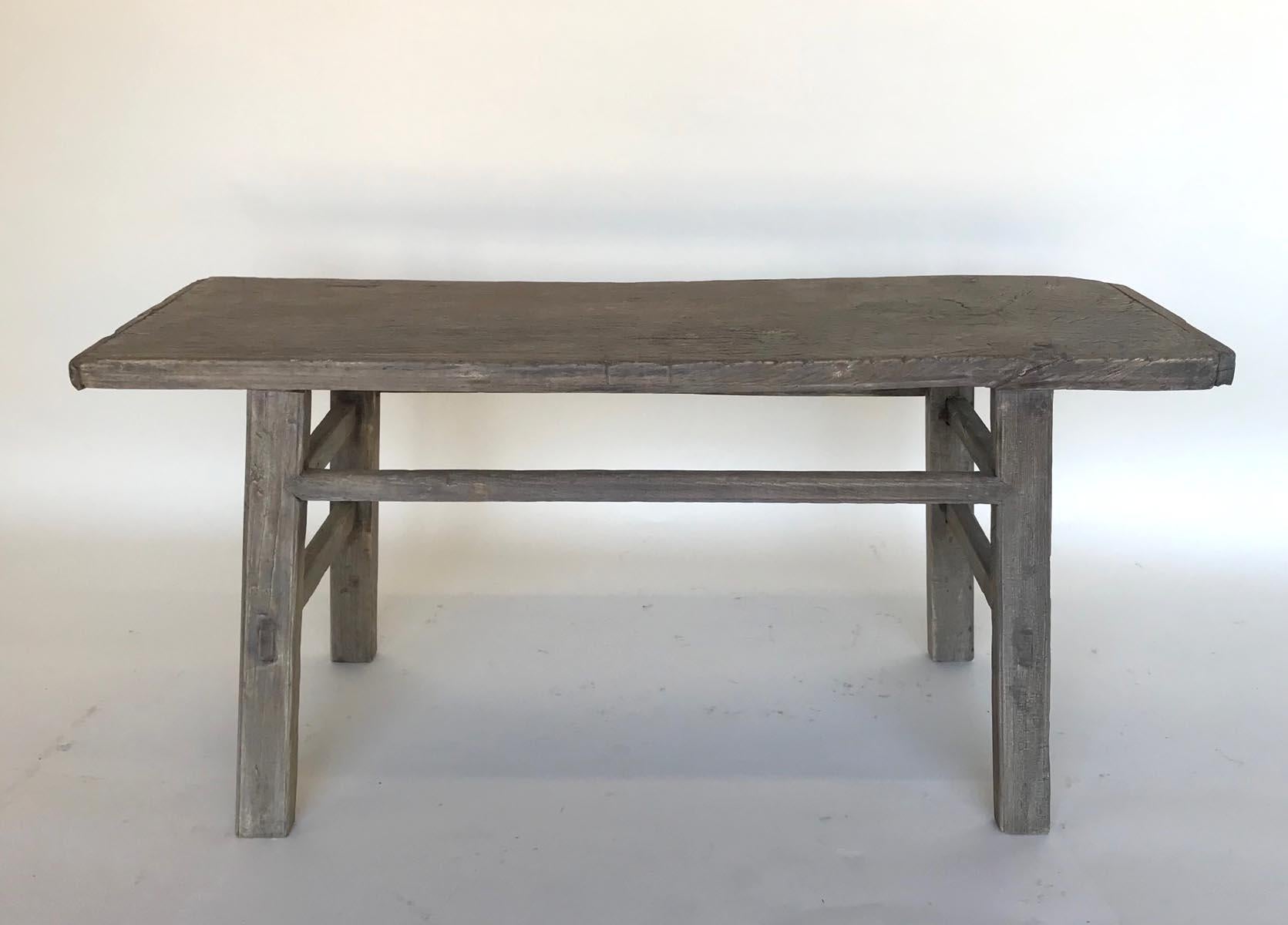 Short vintage elm bench with mortise and tenon construction and double side stretchers. Lovely weathered smooth patina.