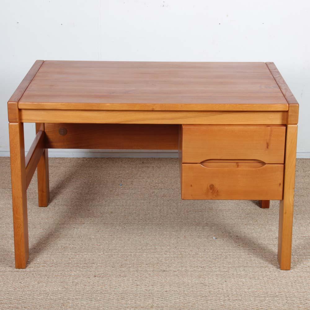 This solid elm desk was produced in France by Maison Regain around 1980. It features two large drawers on the side. This piece of vintage furniture is in good original condition. The top has been restored. 
