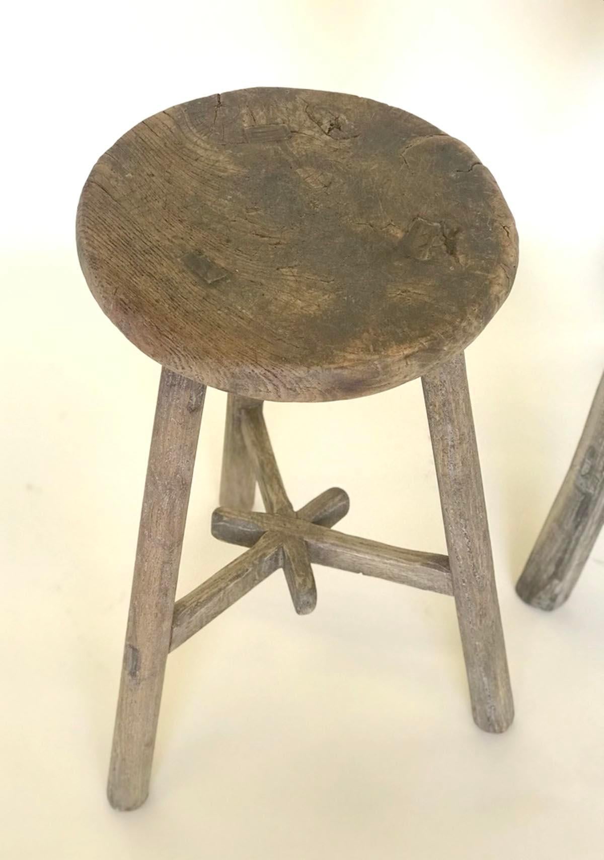 Three vintage elm stools with different configuration on stretchers. Lovely weathered, smooth patina on wood. Mortise and Tenon construction. Great for extra seating, a small side table or as a plant stand.
Sold and priced separately.
Measures: