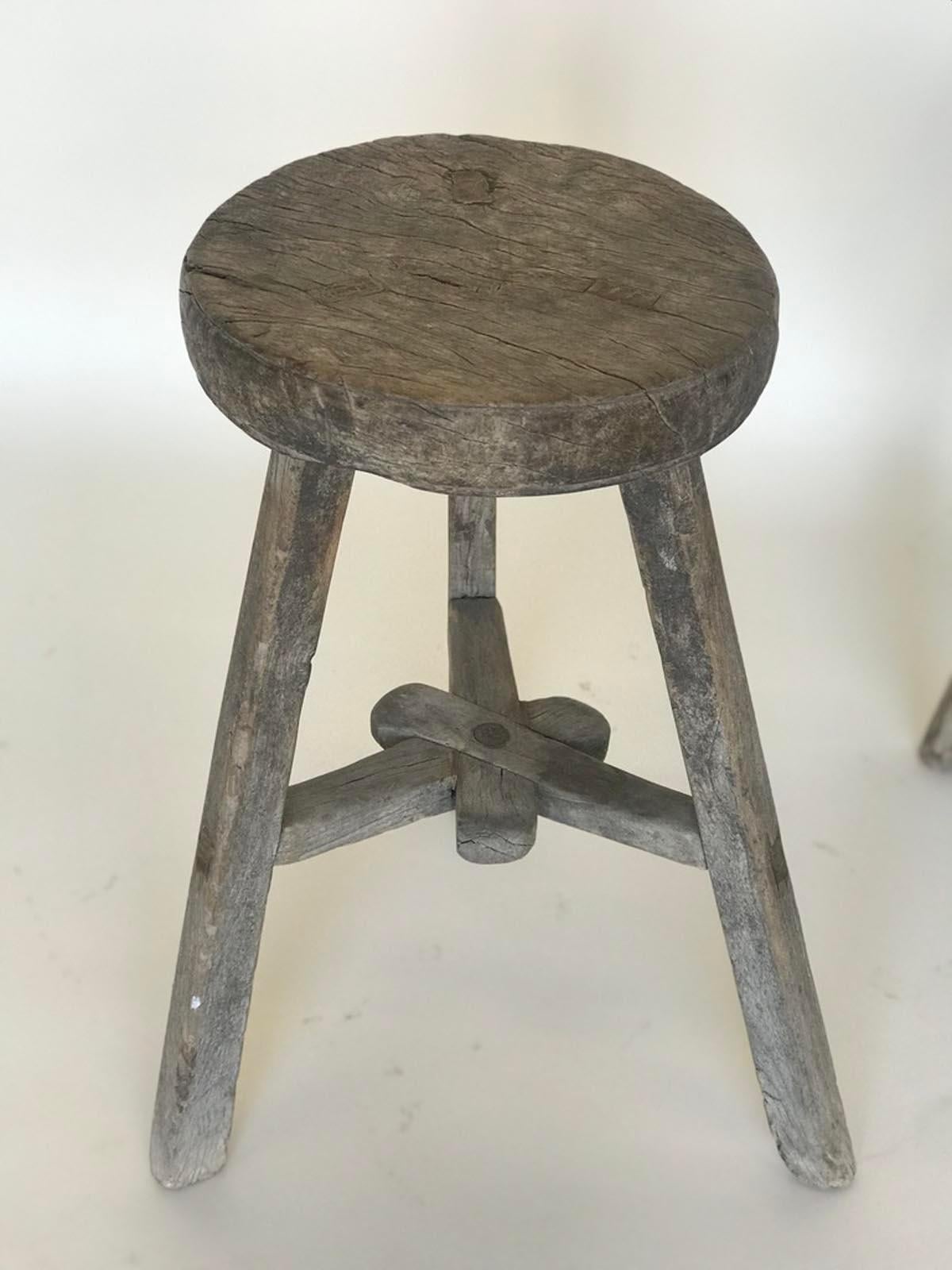 Three vintage elm stools with different configuration on stretchers. Lovely weathered, smooth patina on wood. Mortise and tenon construction. Great for extra seating, a small side table or as a plant stand.
Sold and priced separately.
Measures: