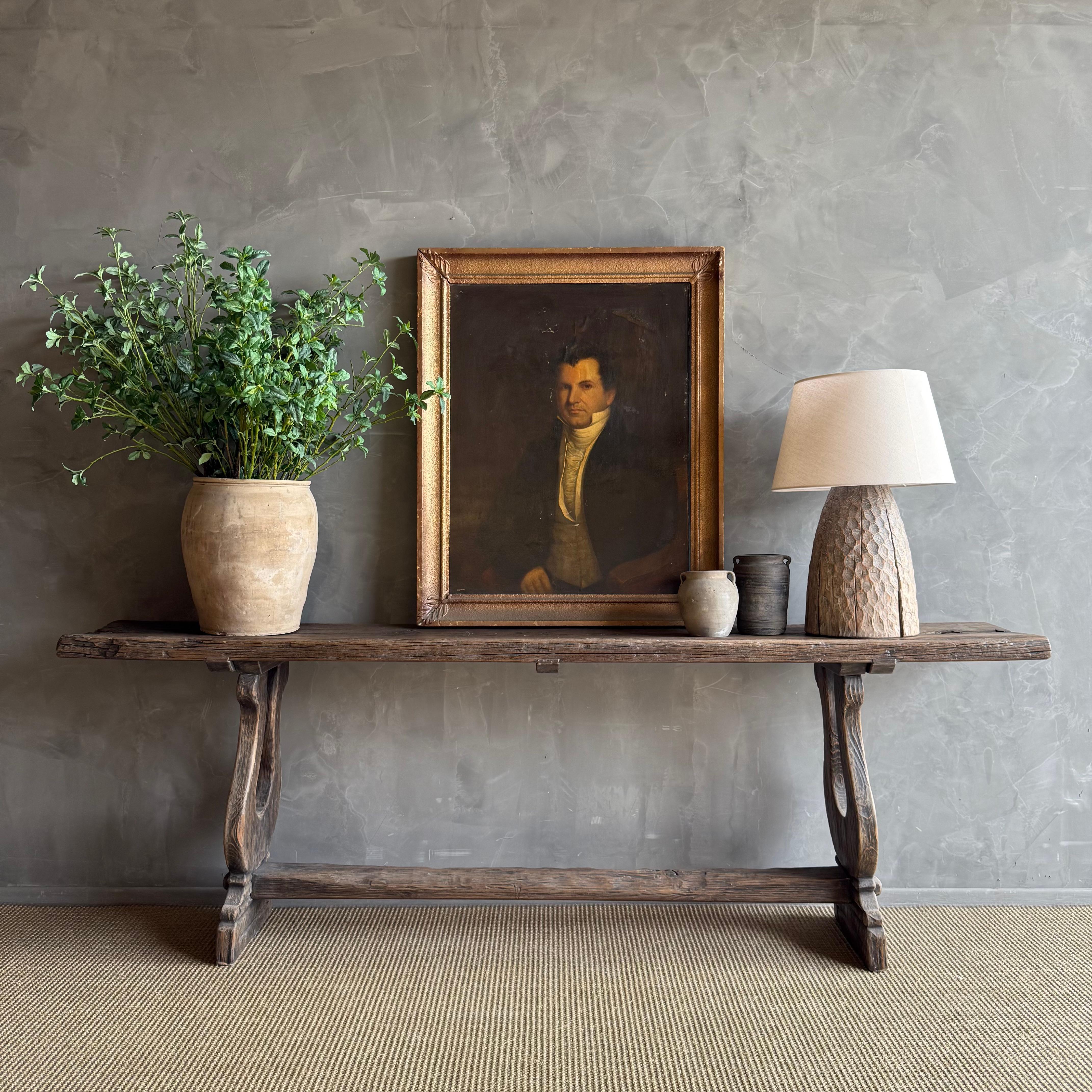 Antique Timber Console, with trestle style base. A dark rustic wood, with original metal ties 
Very solid and sturdy.
Size: 97