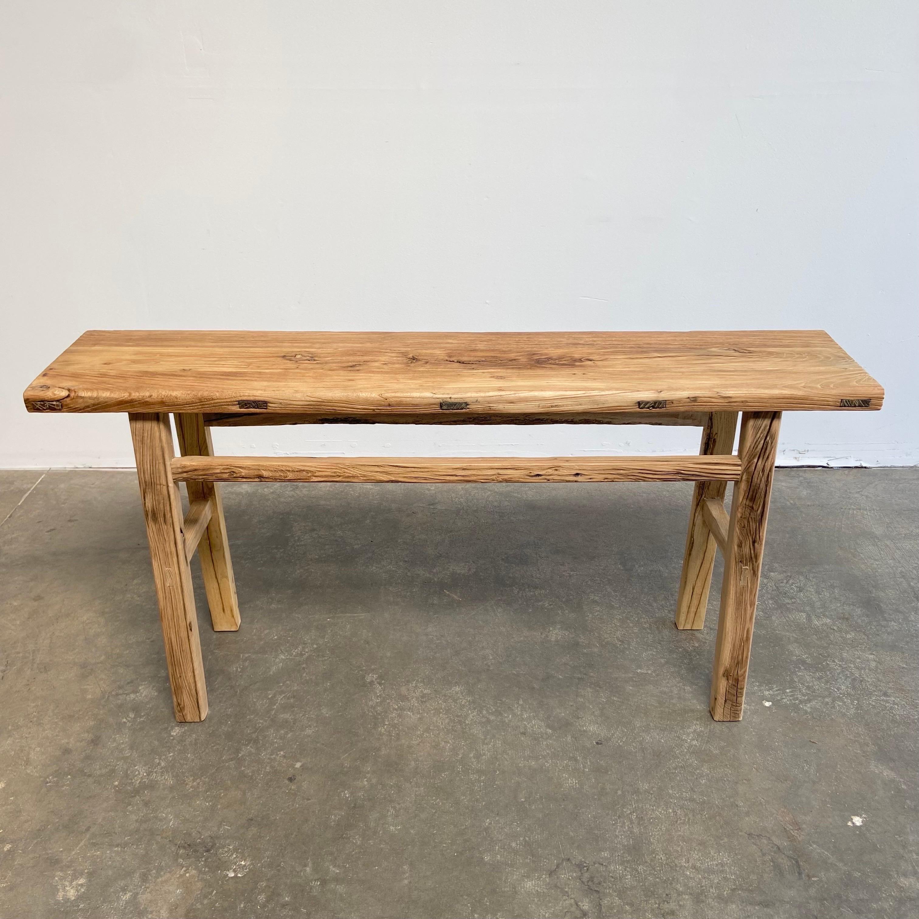 Reclaimed from Vintage timbers, this Elm Wood Console Table features original notches from the door hinges on the inside of the legs. Made from Vintage reclaimed elm wood. Beautiful antique patina, with weathering and age, these are solid and sturdy