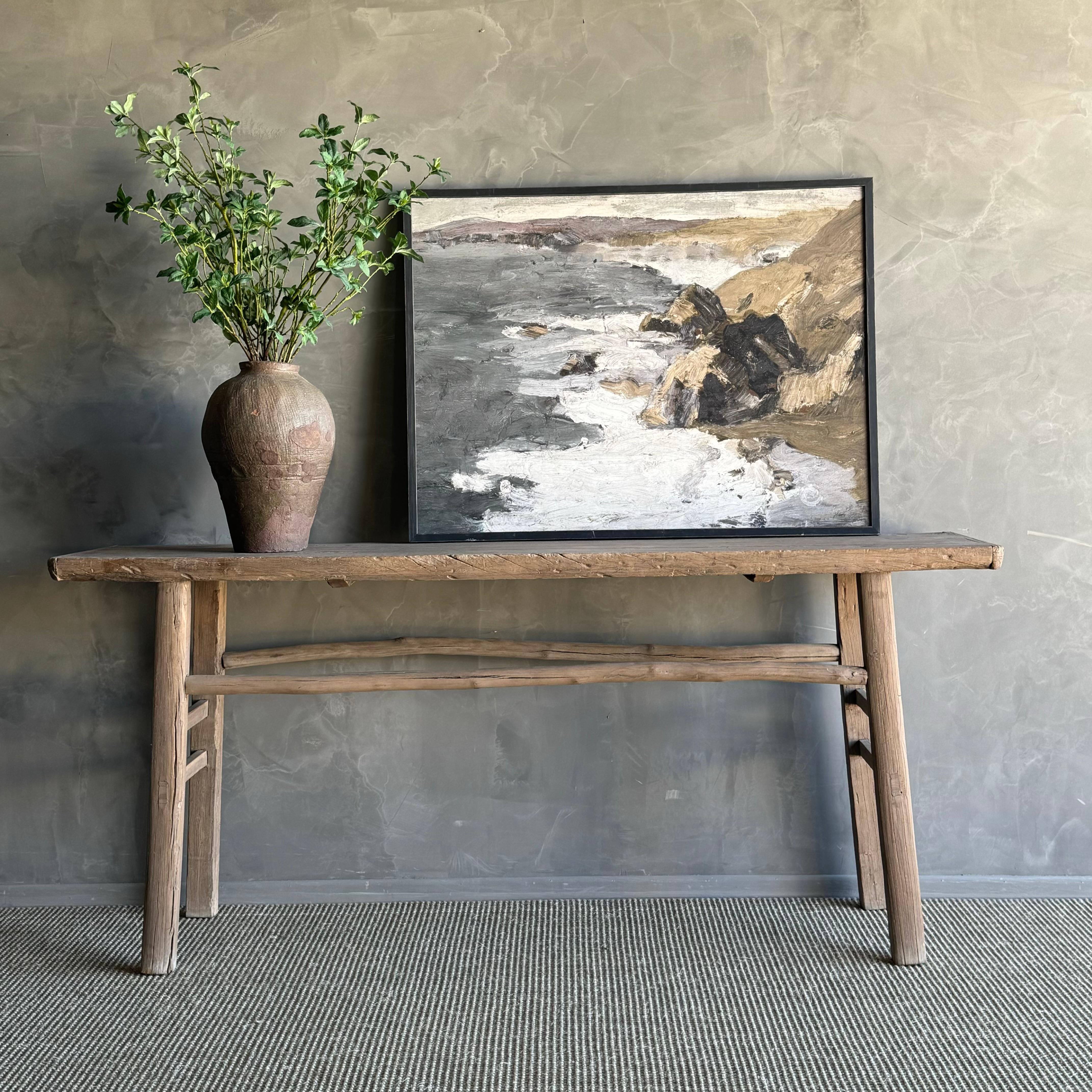 CONSOLE TABLE
Discover the allure of this authentic vintage elm console table. Crafted from a rare find of vintage elm wood, this exquisite piece boasts a natural beauty with unique grain patterns and charming fissures. Each table is one-of-a-kind,