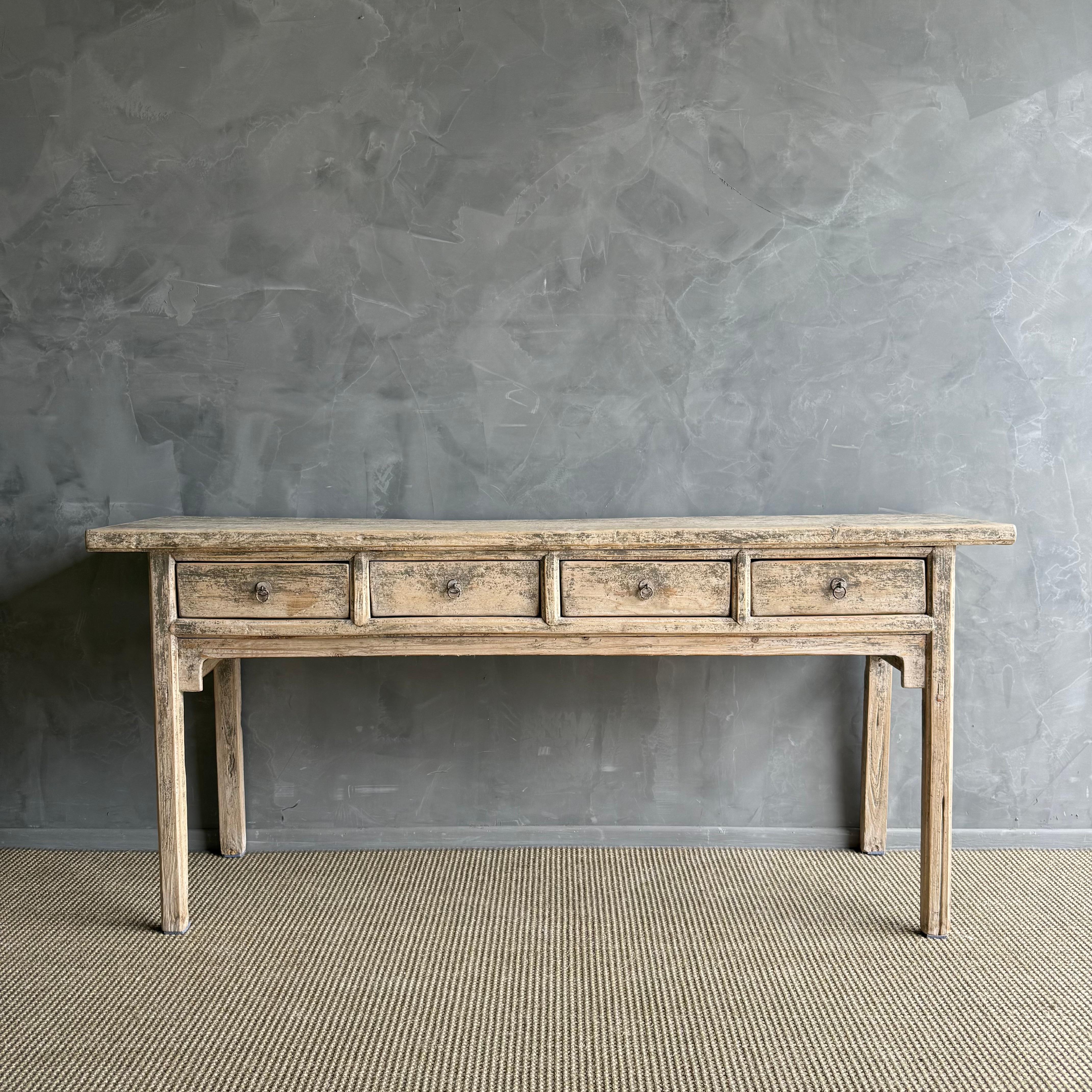 This charming vintage elm wood console is a one-of-a-kind piece with beautiful age and patina that adds character to any space. Its patina painted elm wood finish showcases the natural beauty of the wood, while the solid elm wood original hardware