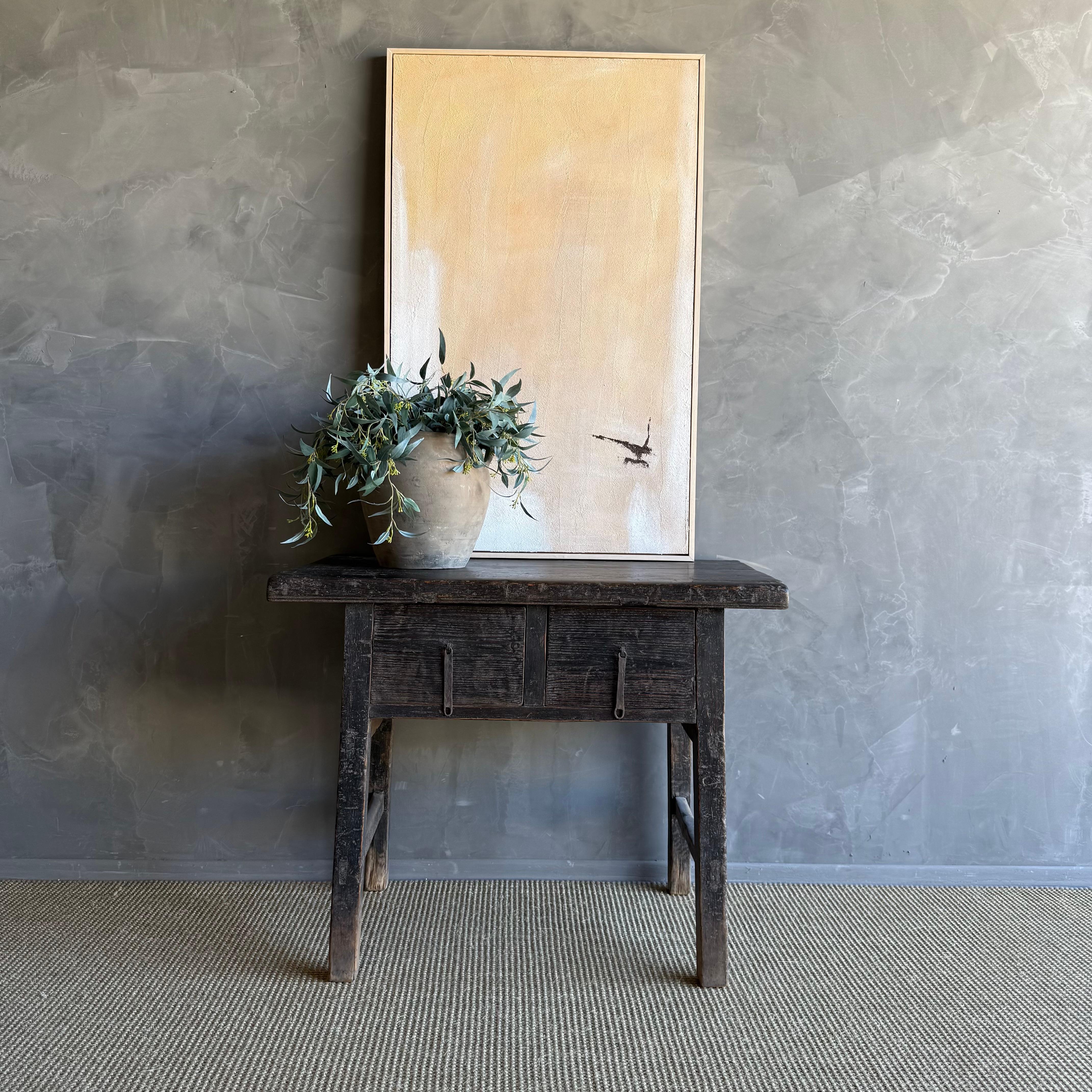 This charming vintage elm wood console is a one-of-a-kind piece with beautiful age and patina that adds character to any space. Its patina painted elm wood finish showcases the natural beauty of the wood, while the solid elm wood original hardware