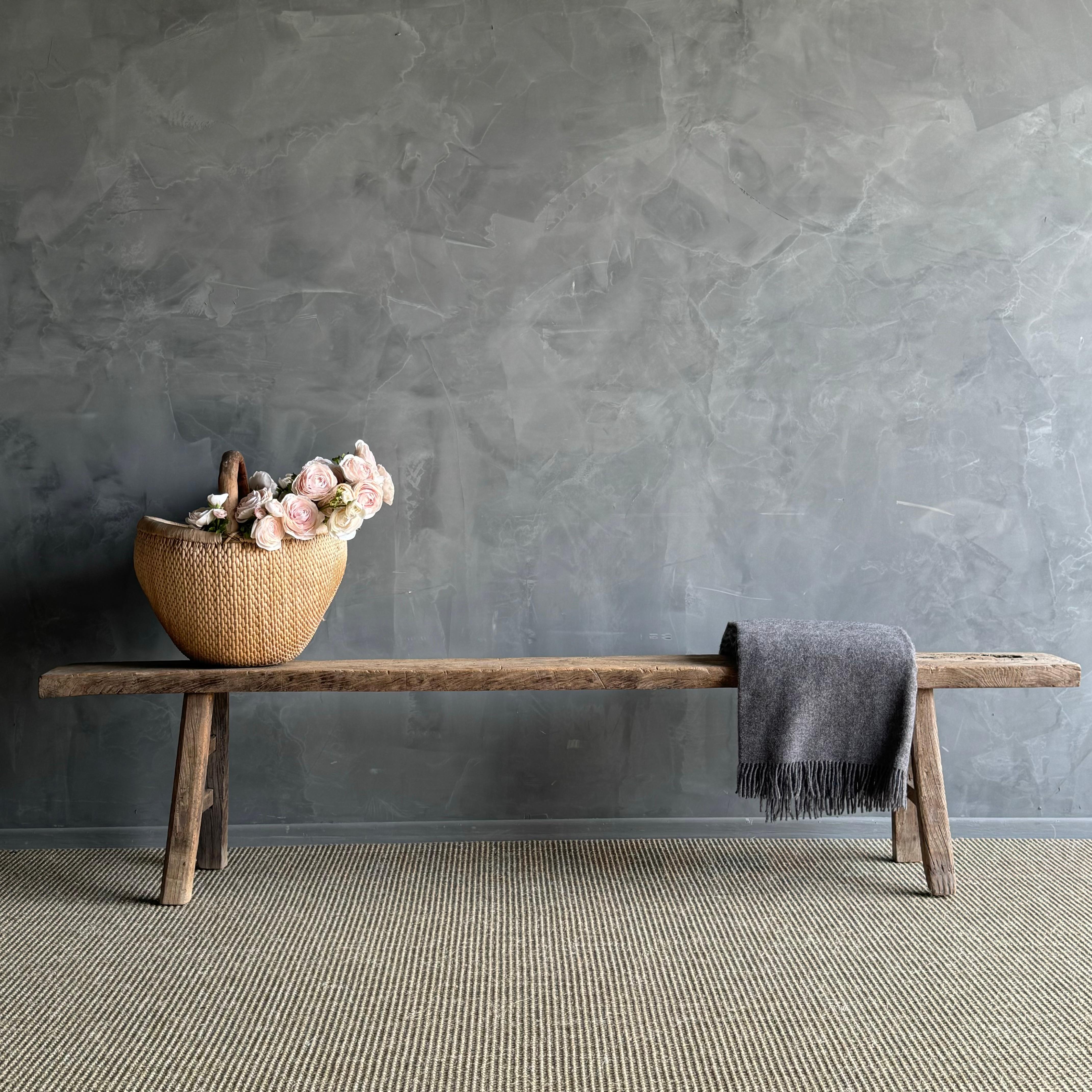 a rare find - the Vintage Elm Wood Long Skinny Bench. This authentic vintage elm bench is a true gem, with a hard-to-find extra long length that makes it stand out. The beautiful grain and fissures add character to each piece, making it truly unique