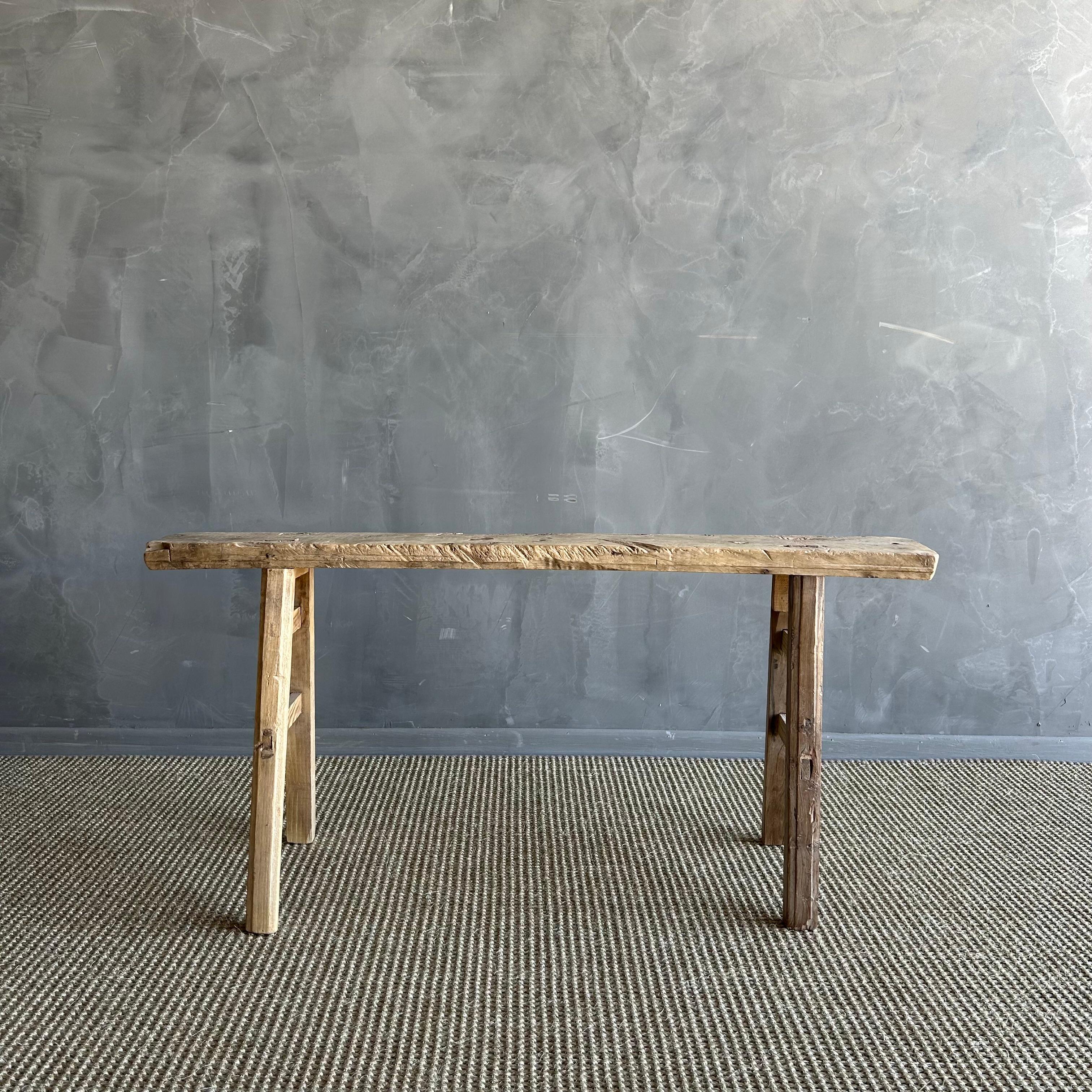 Vintage elm skinny bench.
Crafted from reclaimed elm wood, this bench is not only solid and sturdy but also exudes a charming rustic charm. Perfect for adding character to any room, this bench is ideal for placing at the end of a bed, in the