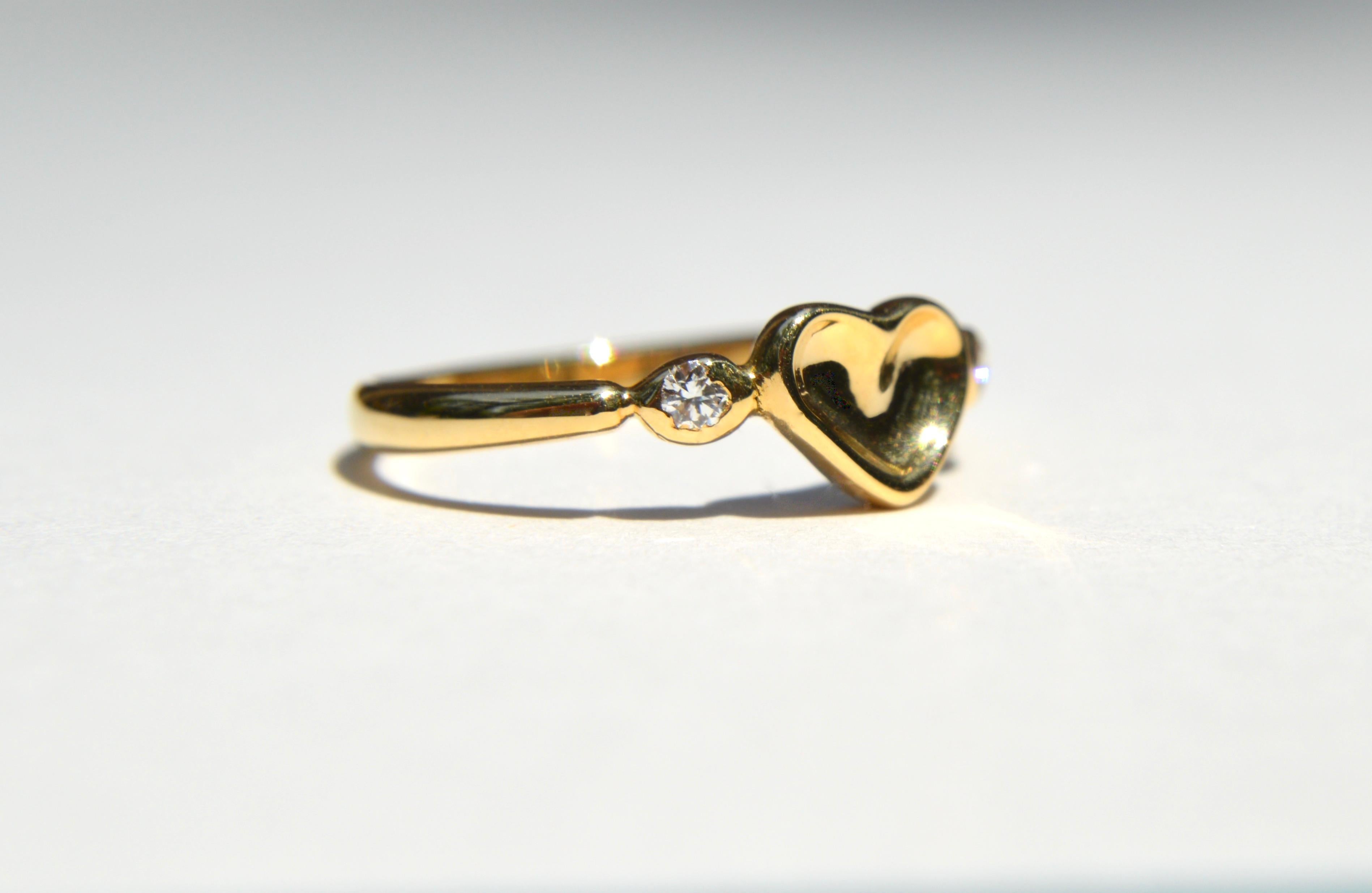 Beautiful vintage Elsa Peretti for Tiffany & Co. circa 1984 18K yellow gold heart ring with 2 diamonds. Size 5, can be resized by a jeweler. In excellent condition. Each sparkling clarity VS1 (very slightly included), color F (near colorless) round