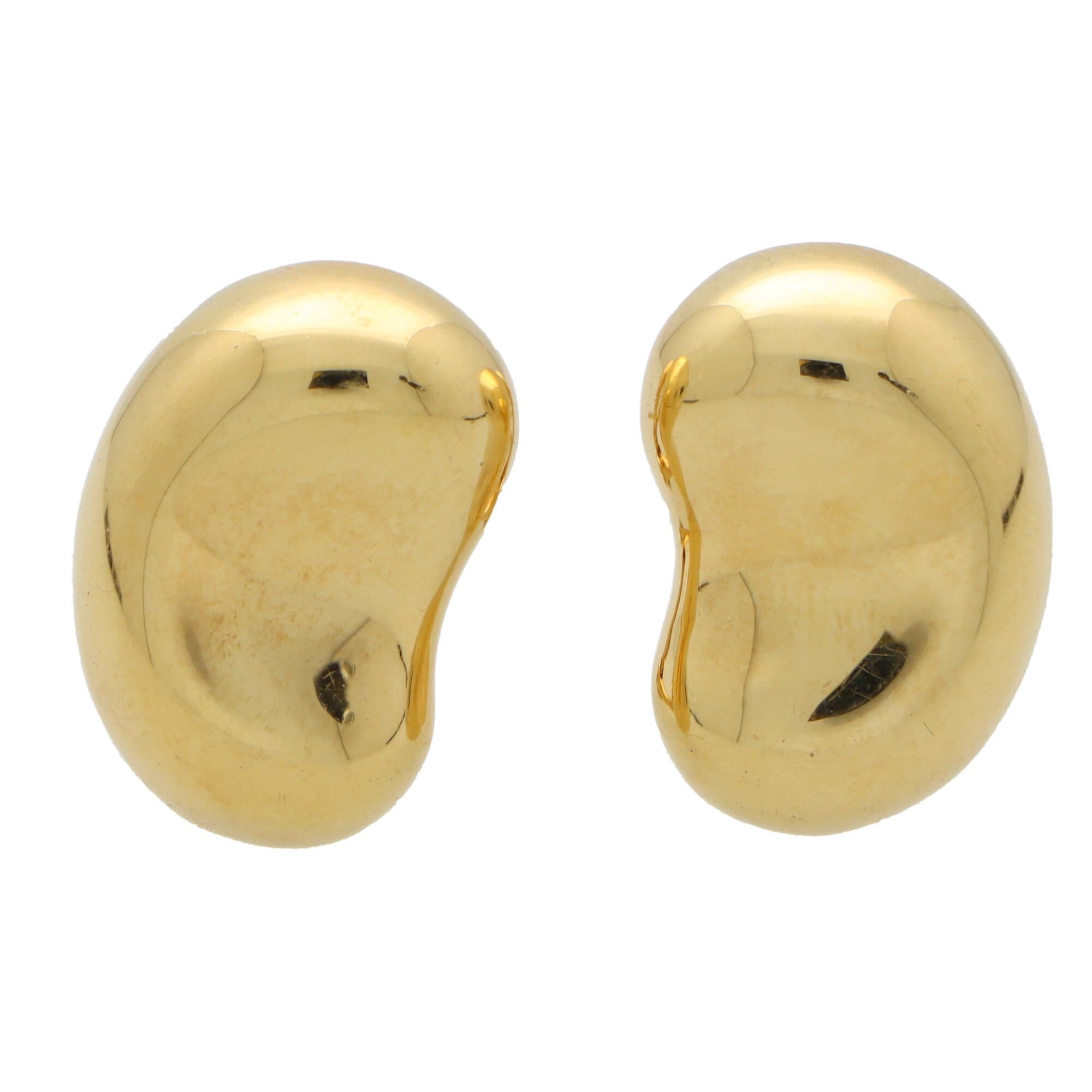 A beautiful vintage pair of Elsa Peretti for Tiffany & Co. bean earrings set in 18k yellow gold.

Each earring is composed in the iconic Elsa Peretti bean motif. The beans are polished gold which look fantastic once on the ear. Both are secured to