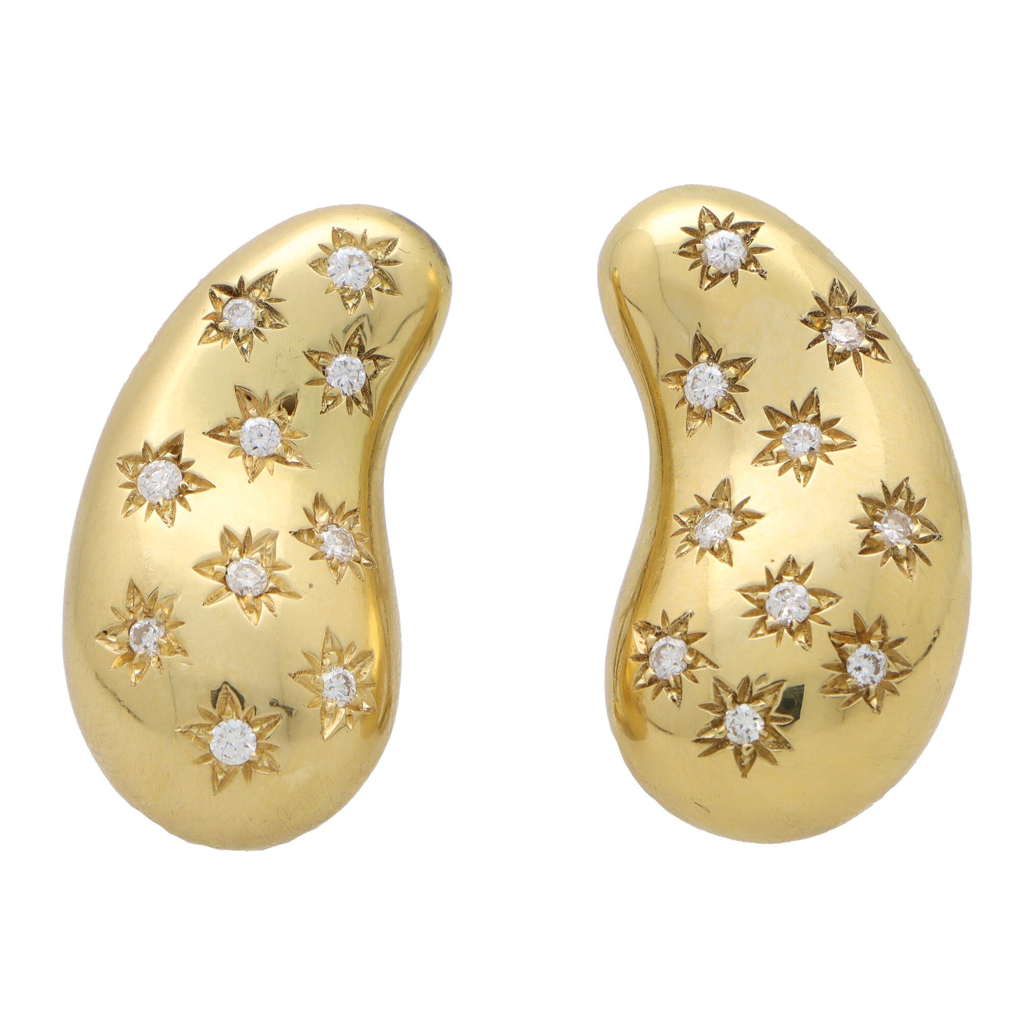  A beautiful vintage pair of Elsa Peretti for Tiffany & Co. diamond bean earrings set in 18k yellow gold. 

Each earring is composed in the iconic Elsa Peretti bean motif, bezel set throughout with ten round brilliant cut diamonds. The diamonds are