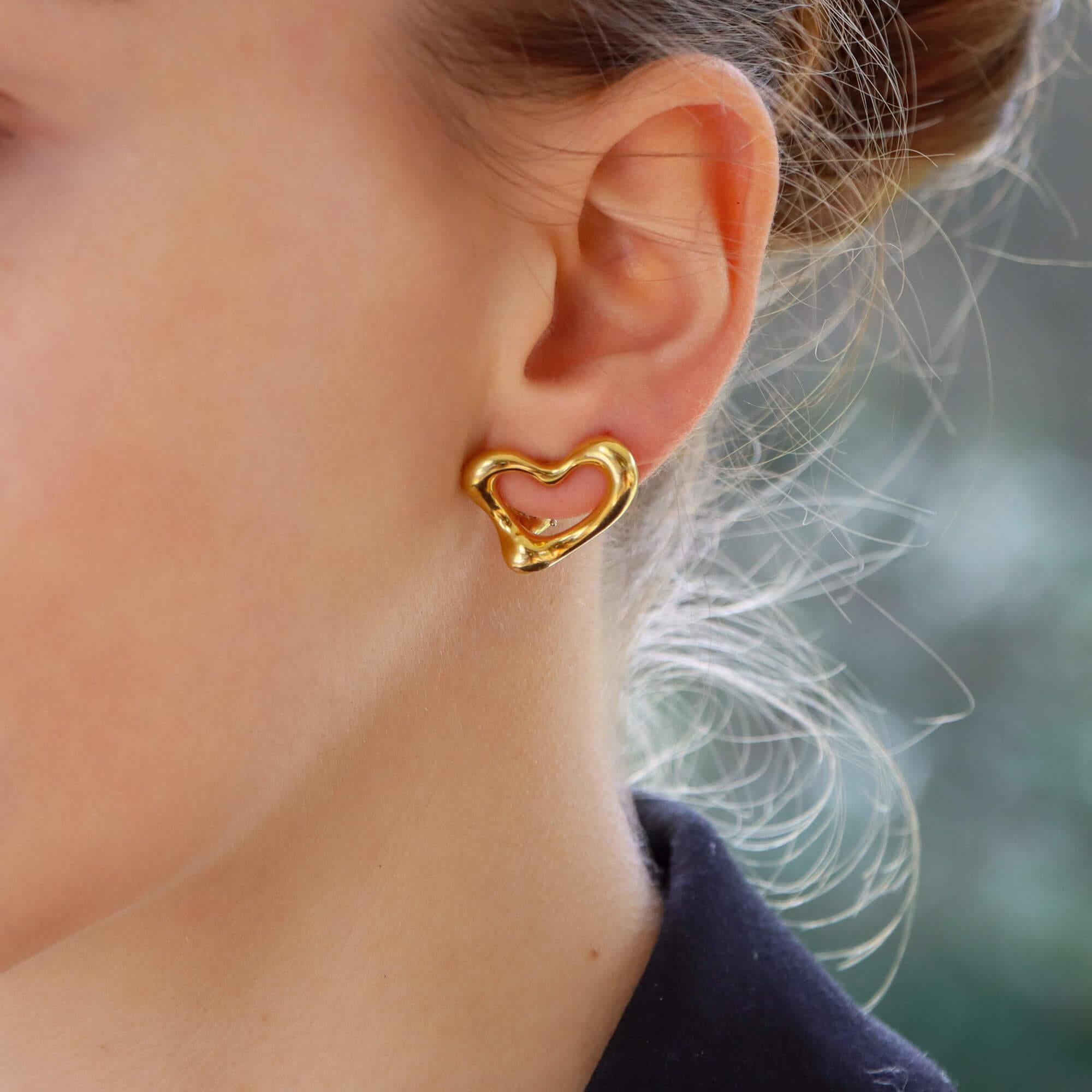 A beautiful pair of vintage Elsa Peretti for Tiffany & Co. open heart earrings set in 18k yellow gold.

From the now discontinued Elsa Peretti open heart collection, each earring depicts an elegant open heart which beautifully curves the ear. Due to