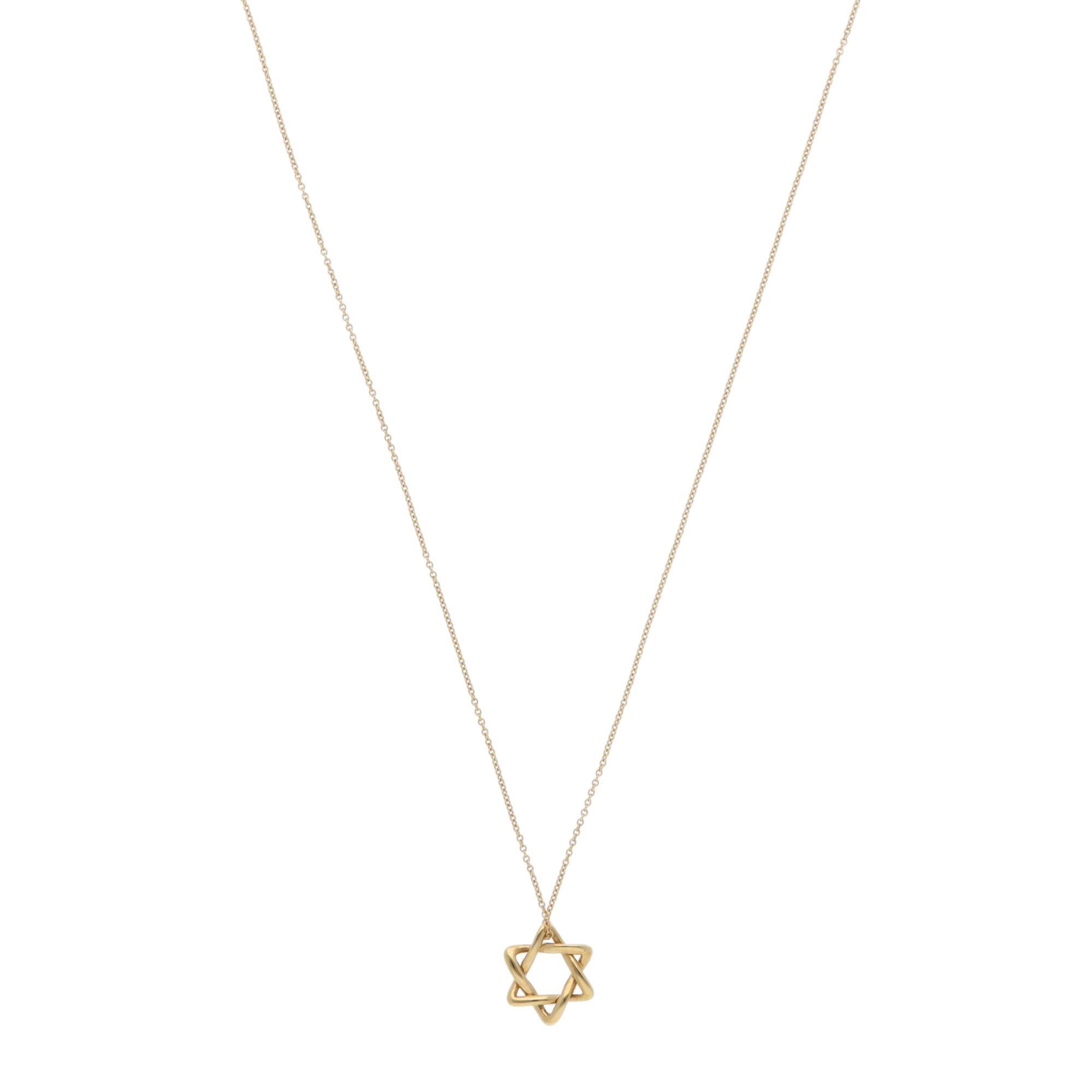 A beautiful vintage Elsa Peretti for Tiffany & Co. Etoile Star of David pendant necklace in 18k yellow gold.

From the current Elsa Peretti collection, the pendant depicts a polished yellow gold Star of David composed of two triangle motifs. The