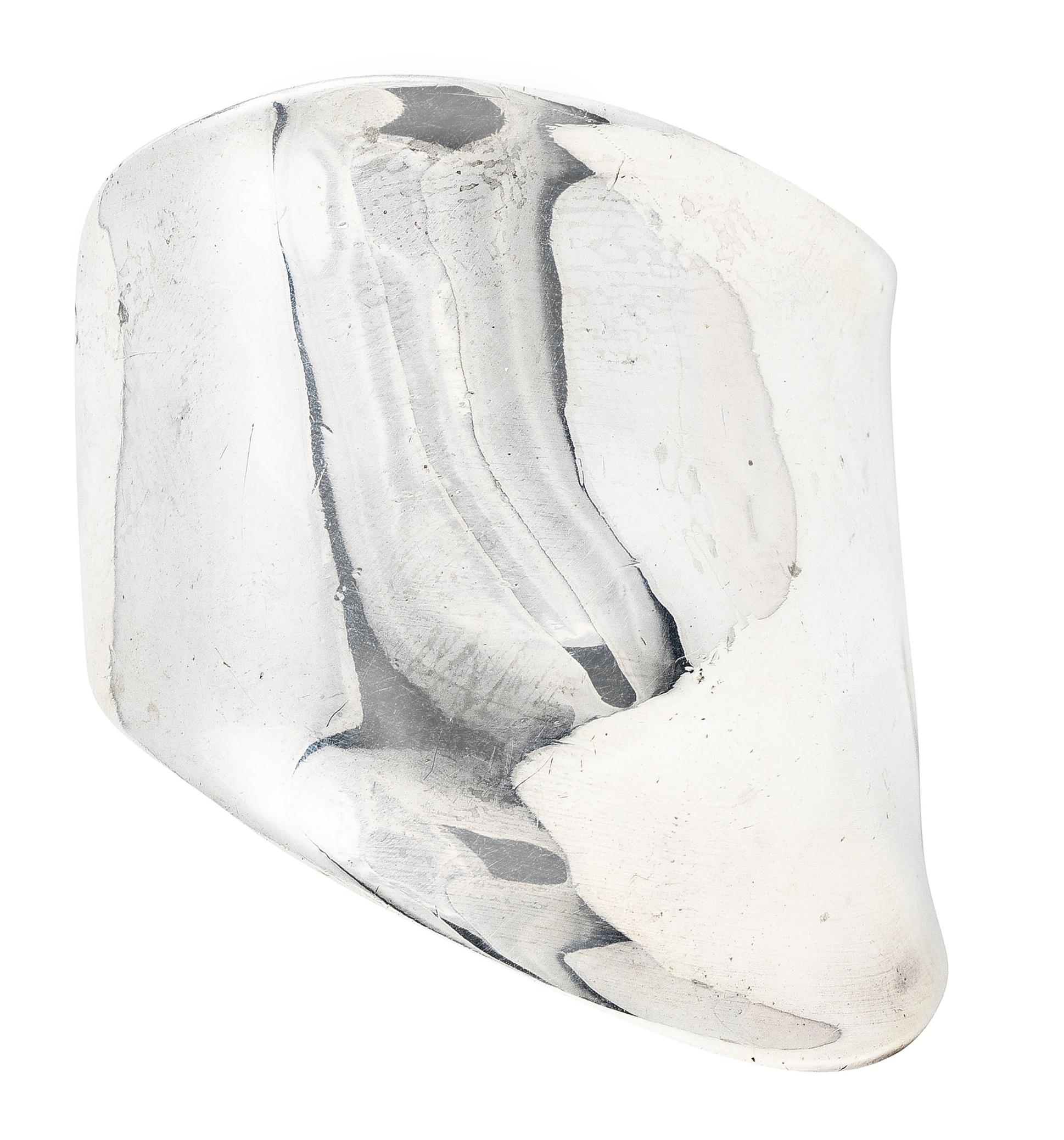 Cuff bracelet is designed as a flowing organic wrist contour. Featuring raised wrist bone motif and subtle fluted edges. With high polished finish. Stamped sterling for sterling silver. Fully signed Peretti Tiffany & Co. for Elsa Peretti Tiffany &