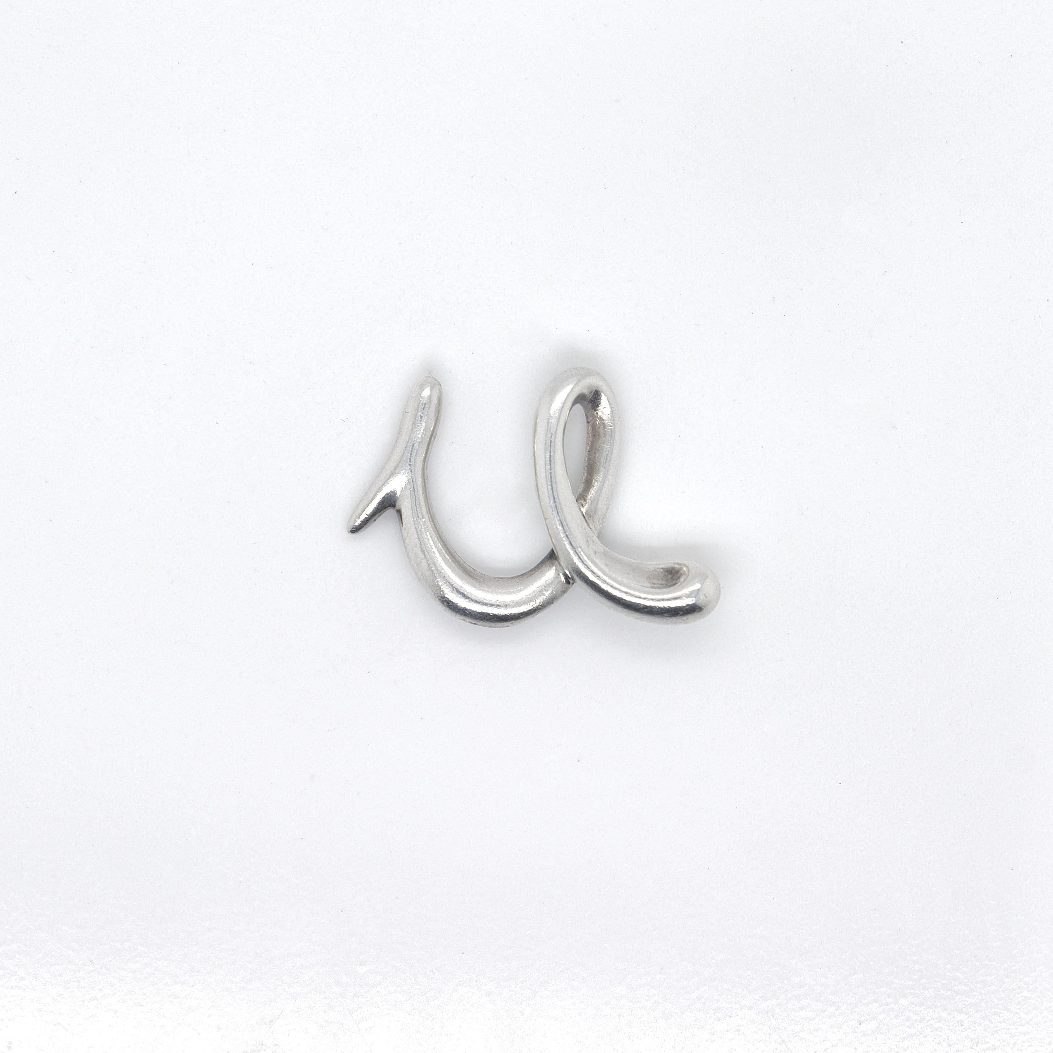 A fine Tiffany & Co. pendant for a necklace.

Designed by Elsa Peretti.

In sterling silver.

In the form of the letter 'u'. 

Simply great Tiffany design!

Date:
Late 20th Century

Overall Condition:
It is in overall good, as-pictured, used estate
