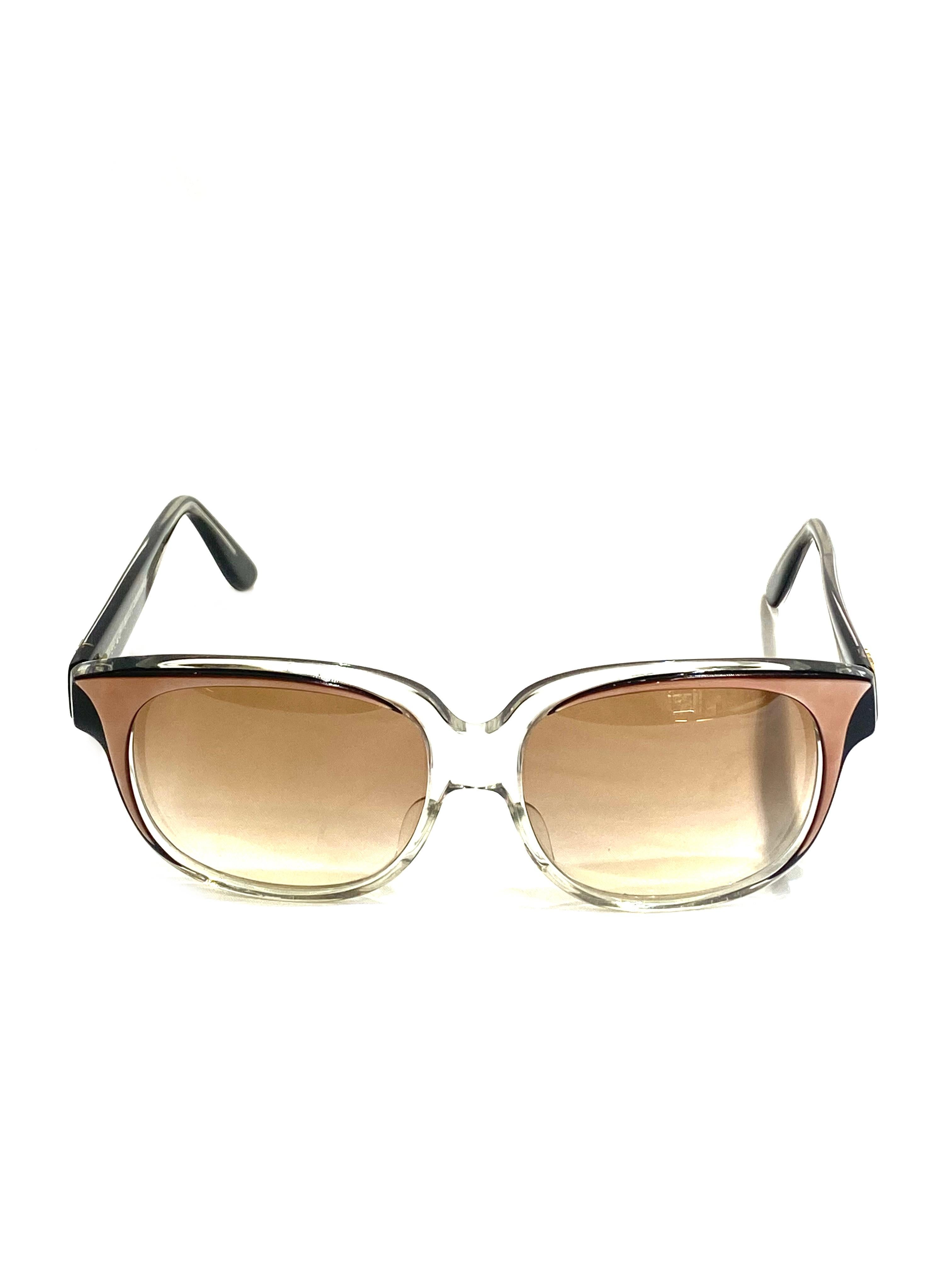 Product details:

Circa 1970.
Featuring clear, black and brown frame with round square brown gradient lens and gold tone EK signature on the sides.
Signed Emmanuelle Khanh Paris B. Robinson.
Handmade in France. 