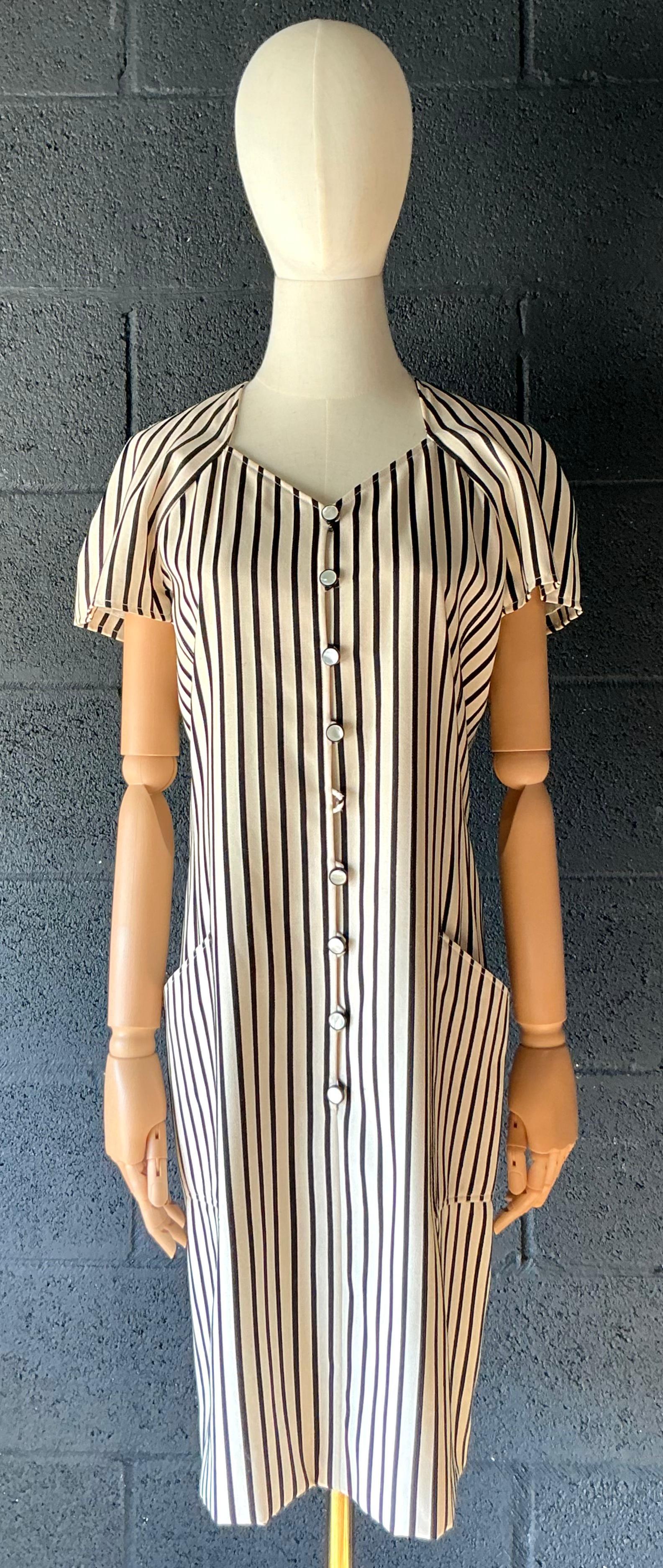 Dieses schwarz-weiß gestreifte Vintage-Kleid von Emanuel Ungaro ist ein kühnes, raffiniertes Statement, das das Gespür des Designers für dramatische Eleganz und fachkundige Schneiderkunst unter Beweis stellt. Das wahrscheinlich aus den 1980er oder