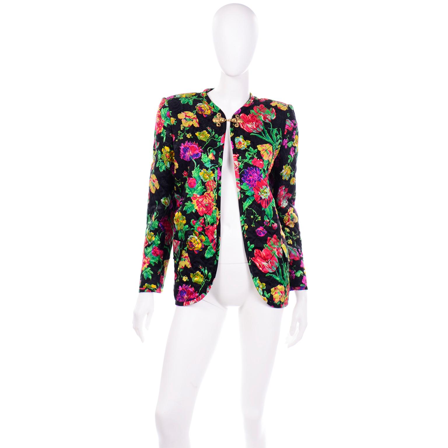 This is a gorgeous vintage deadstock Emanuel Ungaro quilted floral silk jacket with a pretty gold tone hook closure. This colorful jacket is in black silk with bold flowers in vibrant shades of pink, red, purple, green, yellow, violet, mint, and