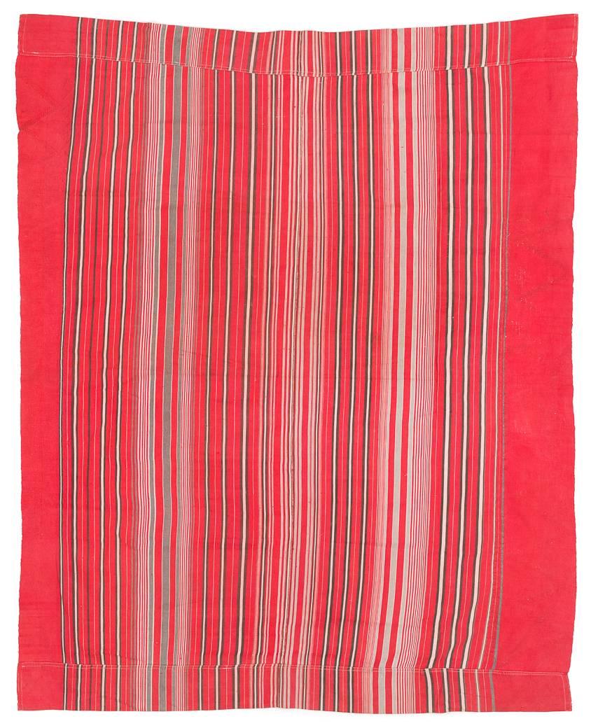 A vintage West African tribal textile from Nigeria. This red, black, and white striped fabric has some chevron stitching and detailing. It is made of excellent handspun cotton and hand embroidery, and has a great vibrant red color. Perfect for a