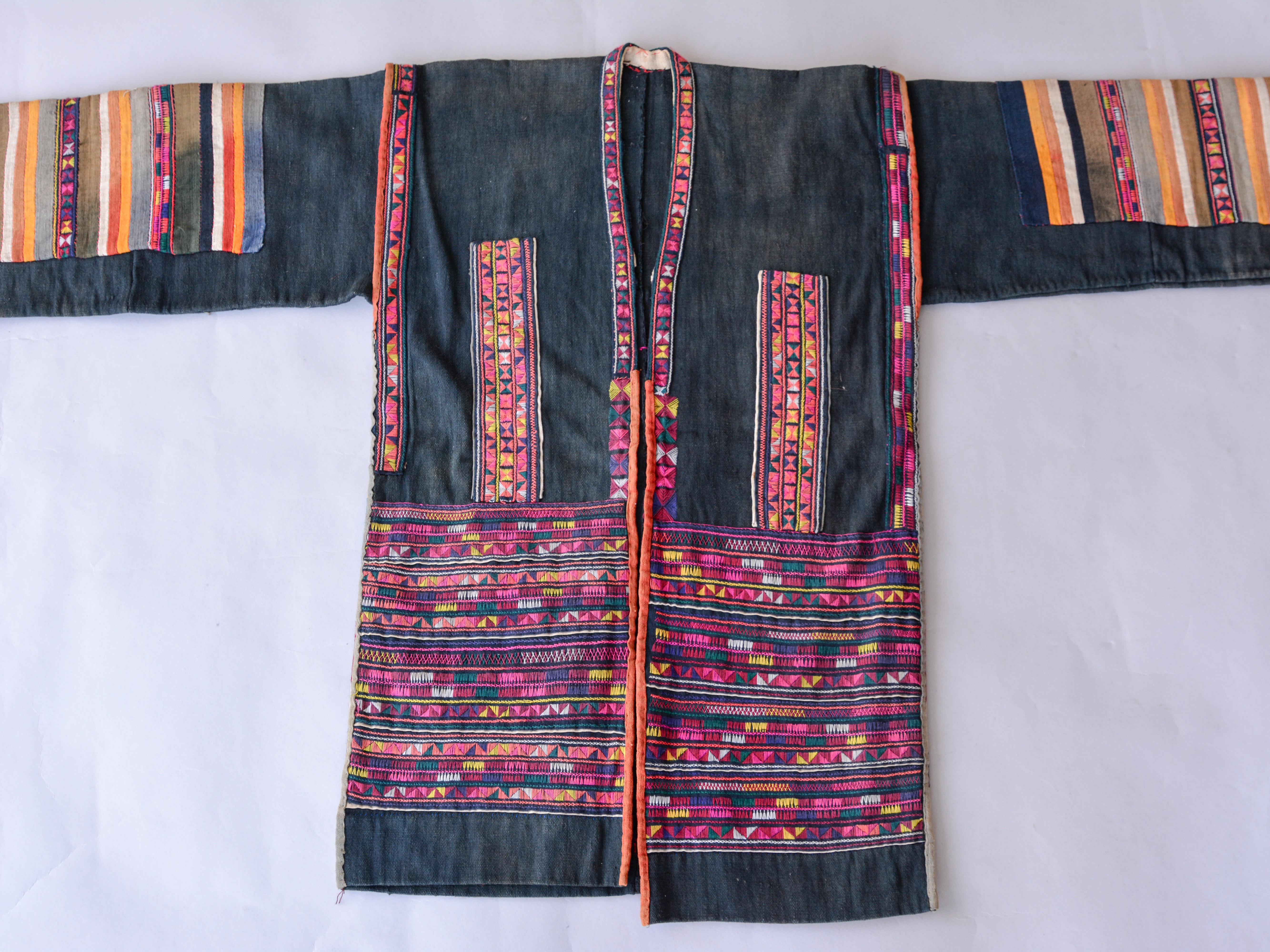 Vintage Embroidered Jacket from the Akha of North Thailand, mid-20th century.
Handspun and handwoven indigo dyed cotton with brightly colored cotton embroidery.
This is a women's jacket from the Akha, an important minority group of people