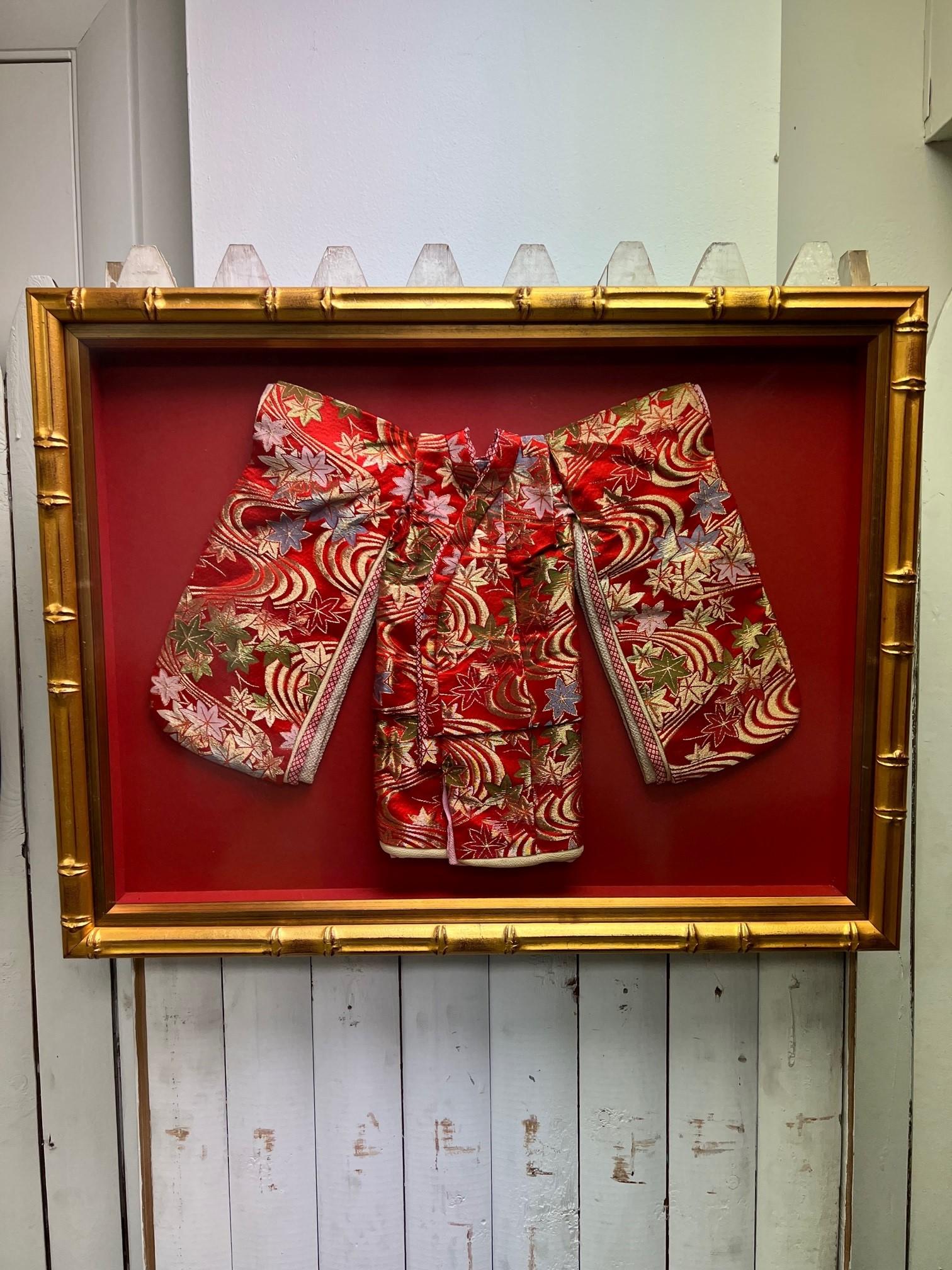 Beautiful rare vintage hand sewn one of a kind Japanese ceremonial child's kimono in a gold bamboo framed shadowbox. Kimono for children are shaped and styled much like those for adults, but are almost always in bright patterns and prints. This is a