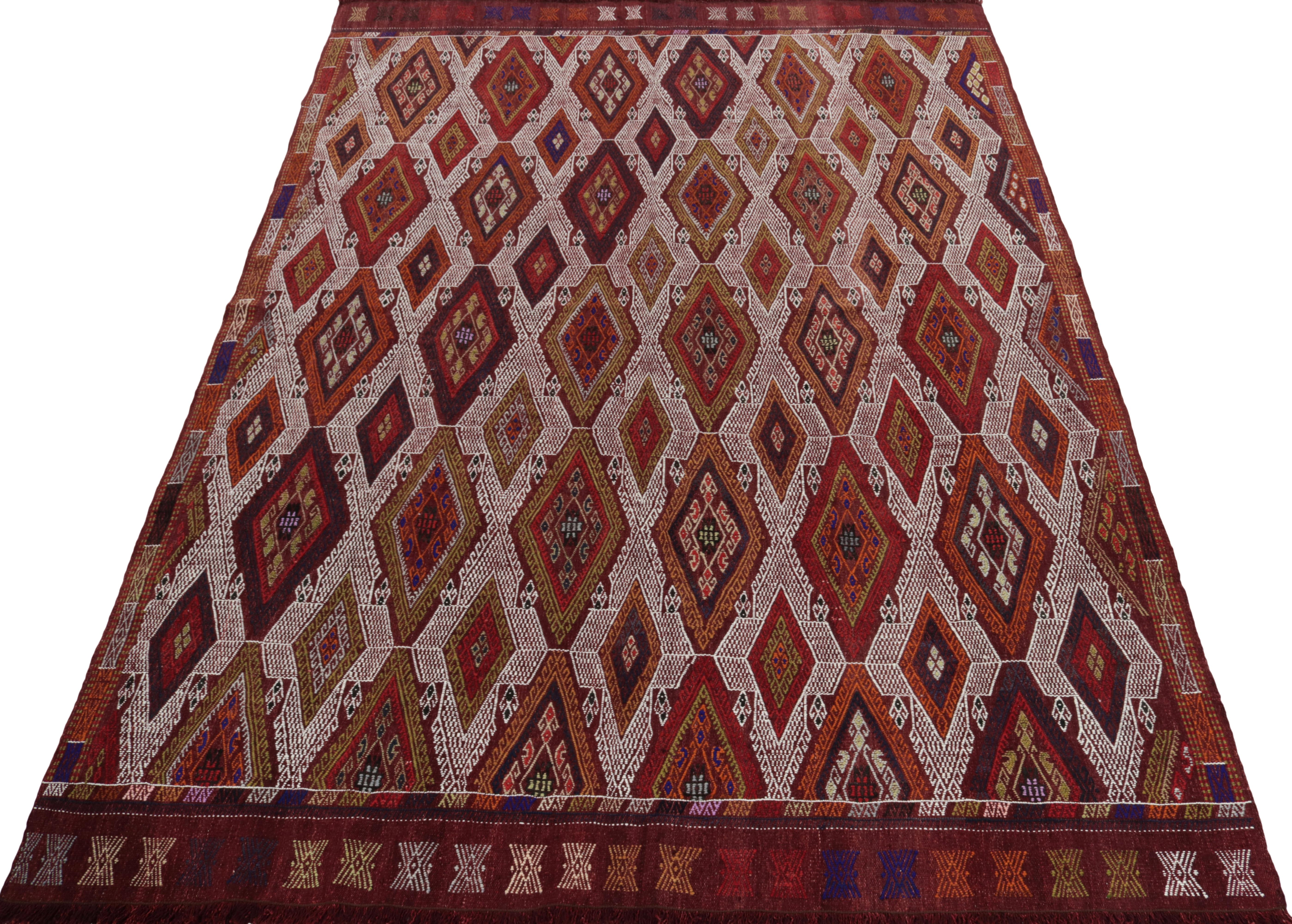 Handwoven in fine quality wool, a 5x7 kilim rug from Turkey circa 1950-1960 joining our Kilim & Flatweave collection. 

The vintage flat weave enjoys fine embroidery height in a burgundy & white colorway with beautiful accenting colors, bringing a