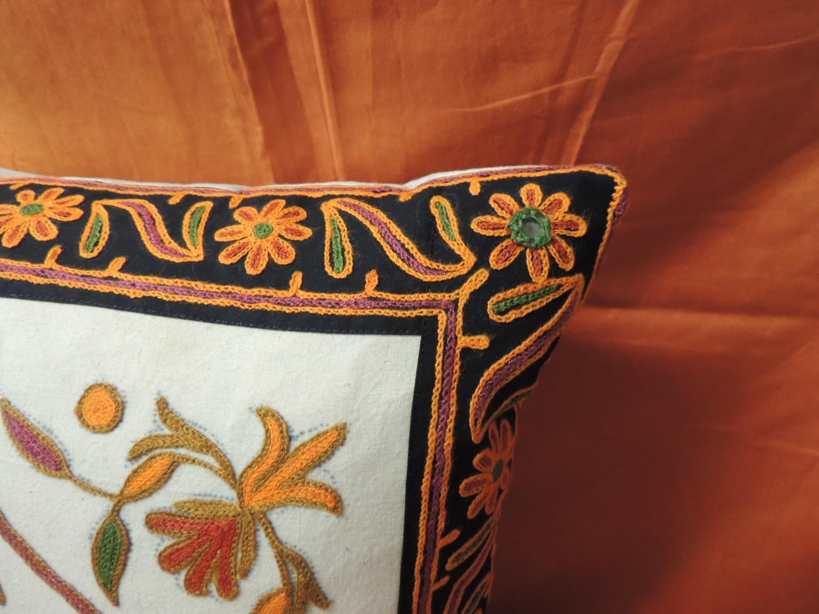 orange embroidered pillow