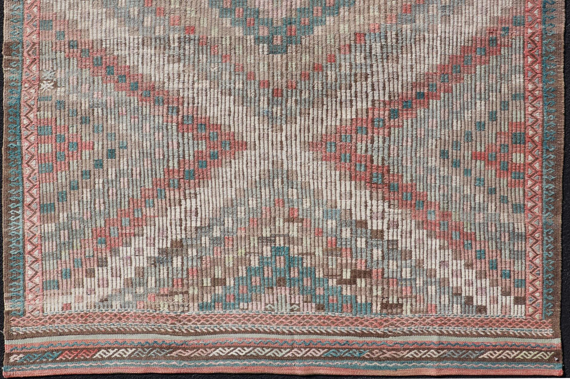 Teal blue, brick red, pink, salmon, teal green, cream, soft buttery yellow and light green populates throughout this beautiful vintage embroidered Kilim rug from Turkey, rug EN-2395, country of origin / type: Turkey / Kilim, circa 1940

Featuring