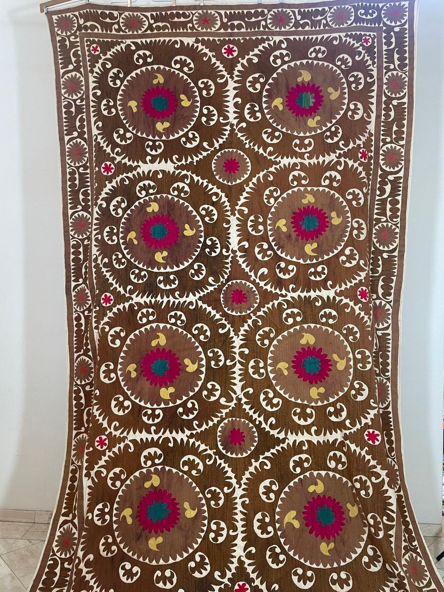 Large Vintage Embroidered Uzbekistan Suzani Tapestry Wall Hanging Brown and Pink.
Very large vintage Turkish Suzani is heavily hand-embroidery with organic brown, pink and yellow colors silk threading.
Beautiful Uzbek hand stitched designs with silk