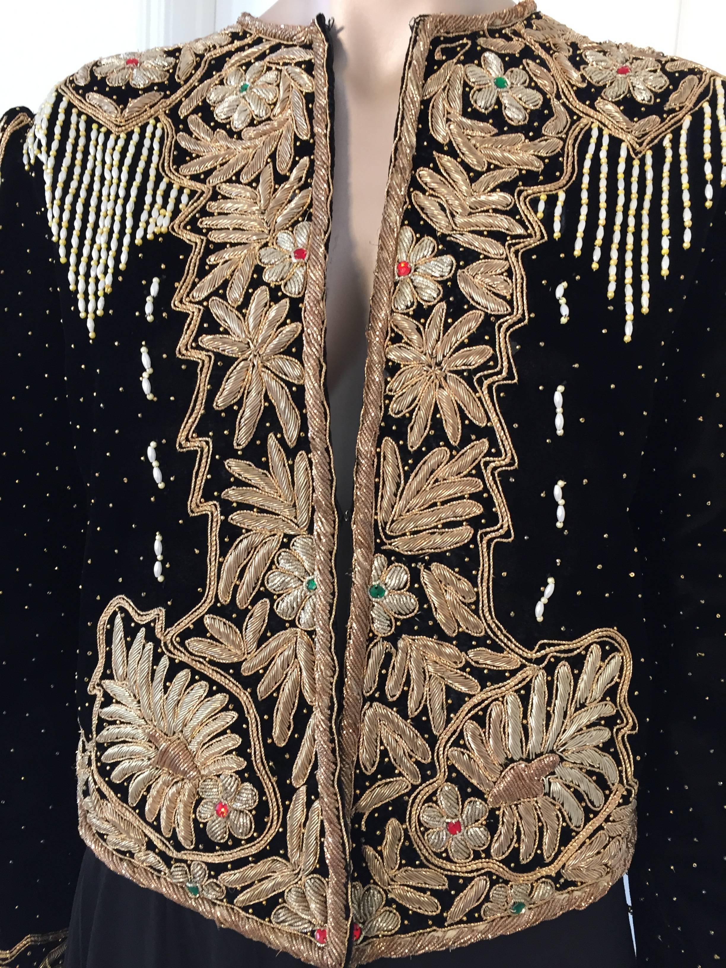 Magnificent 1980s vintage embroidered silk velvet evening two pieces gown, vest and skirt
The stunning beaded and sequined evening custom made black silk velvet blazer is detailed with gold of micro seed glass beads, gold tone round beads, gold lame