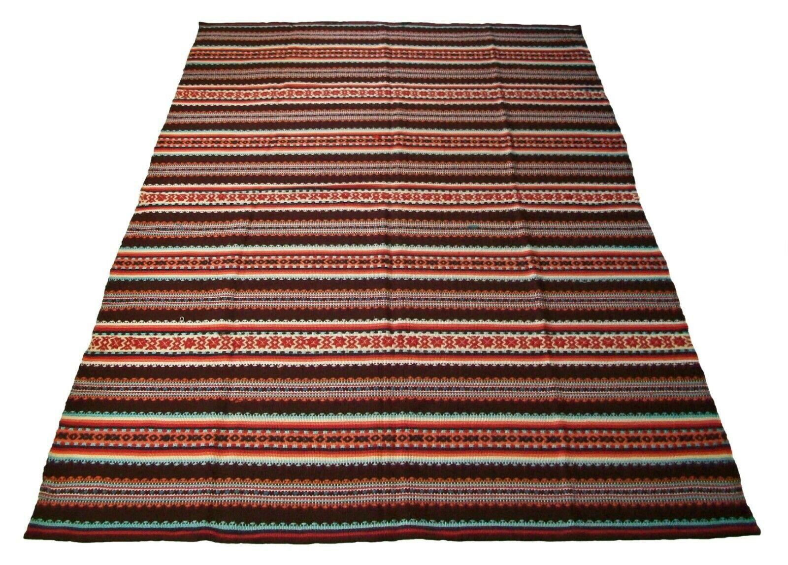 Vintage folk art serape blanket or area rug - medium size - hand loomed with 100% wool weft on a cotton warp - elaborate embroidered geometric sections repeated over the length of the weaving add extra dimension and detail - folded and sewn ends -