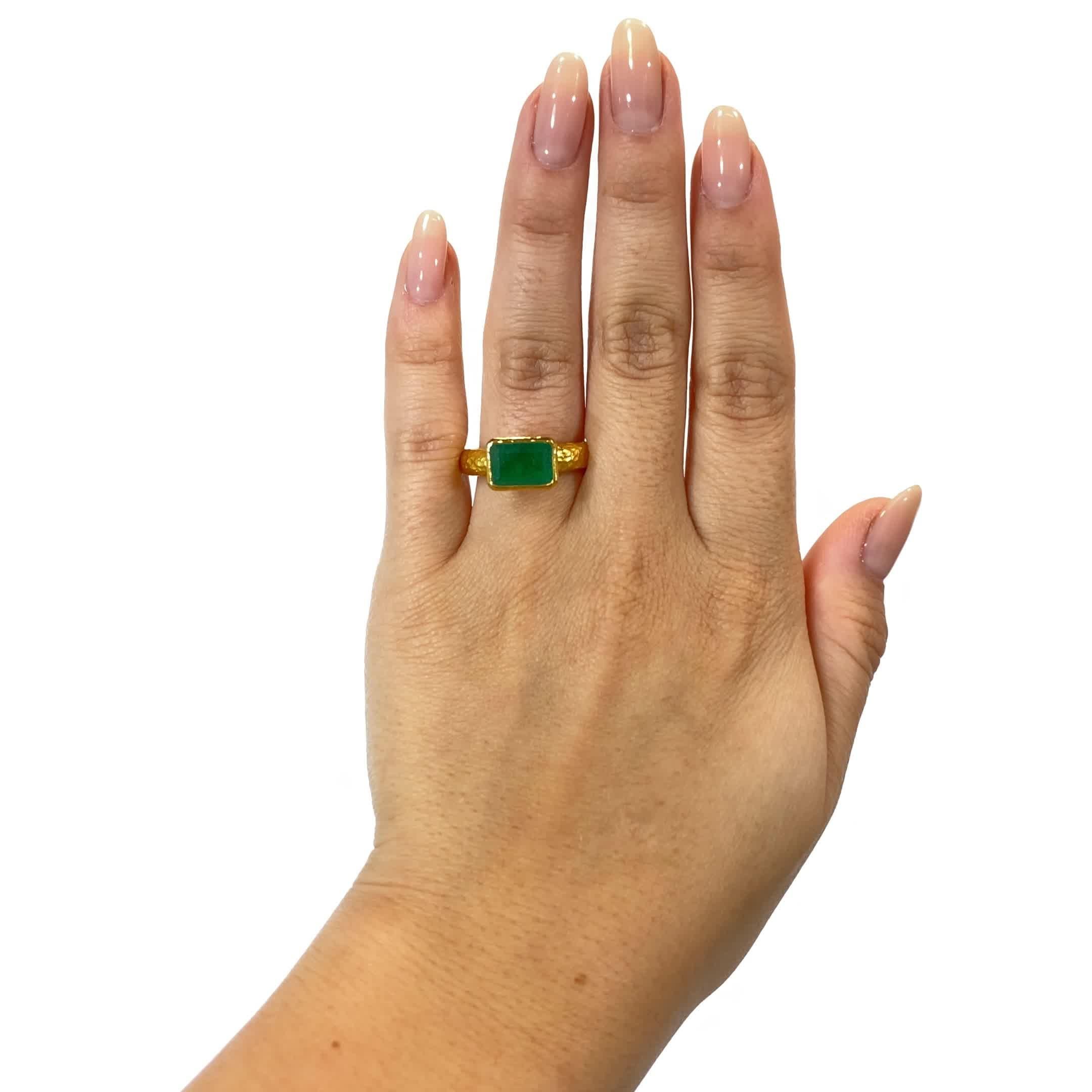 Vintage Emerald 22 Karat Gold Solitaire Ring. The ring features a rectangular emerald, approximately 1.70 carats. Circa 2000s. Size 6 1/4.

About The Piece: Feel yourself like an  Amazon Goddess, with this vibrant buttery 22 Karat gold ring. The