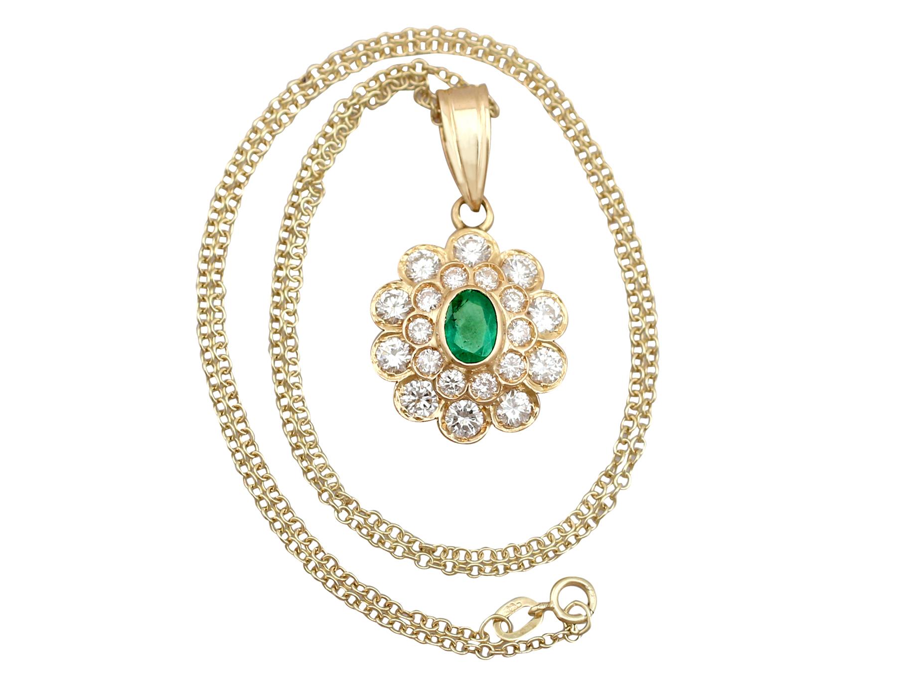 A stunning, fine and impressive vintage 0.60 carat natural emerald and 2.28 carat diamond, 18 karat yellow gold pendant; an addition to our vintage jewelry and estate jewelry collections.

This stunning vintage emerald pendant has been crafted in