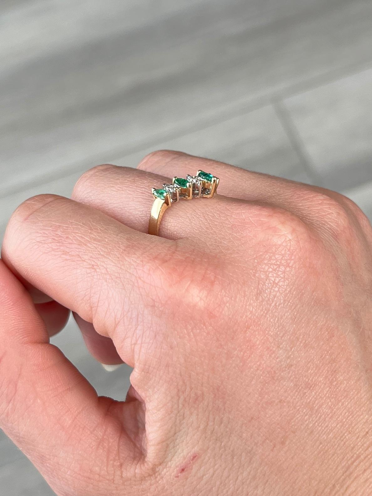 This gorgeous band holds four emeralds measuring a total of 25pts and in between there are pairs of diamonds. The diamonds total 16pts. Modelled in 14carat gold. 

Ring Size: M or 6 1/4 

Weight: 2.2g