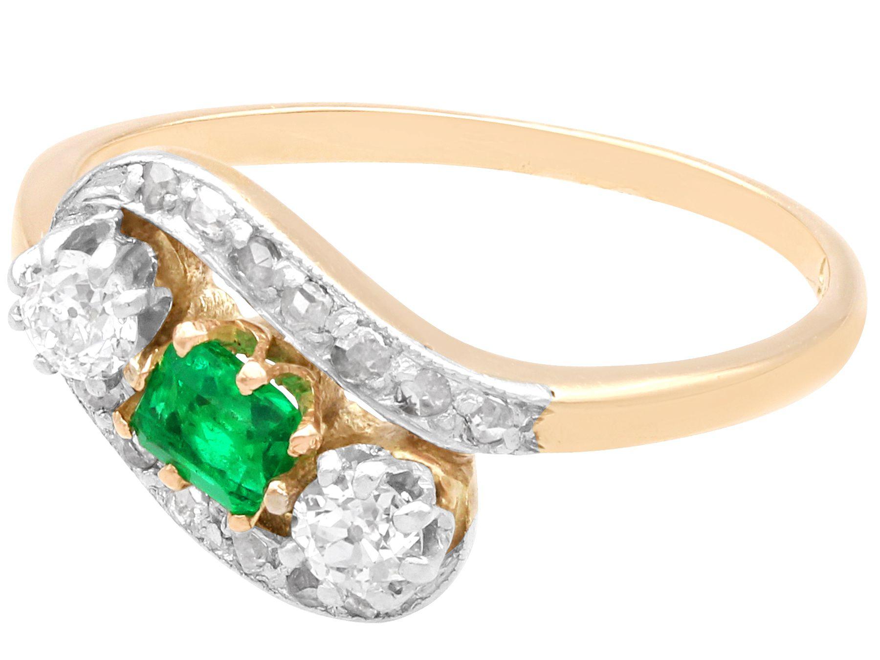 A fine and impressive antique 0.28 carat emerald and 0.45 carat diamond, 14 karat yellow gold twist ring; part of our diverse vintage jewelry collections.

This fine and impressive vintage emerald and diamond ring has been crafted in 14k yellow gold